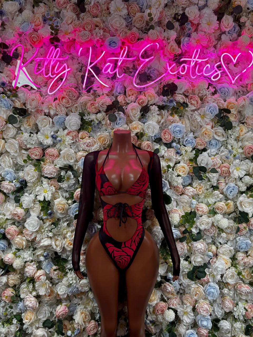 Sheer long-sleeve rose-print bodysuit with deep V neckline on mannequin