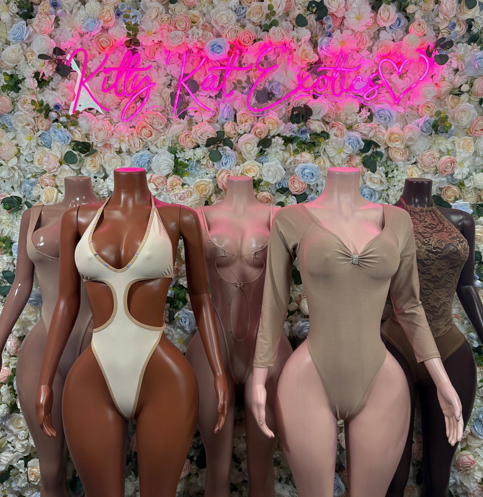 Tan one-piece dance bodysuit with long sleeves and V neckline