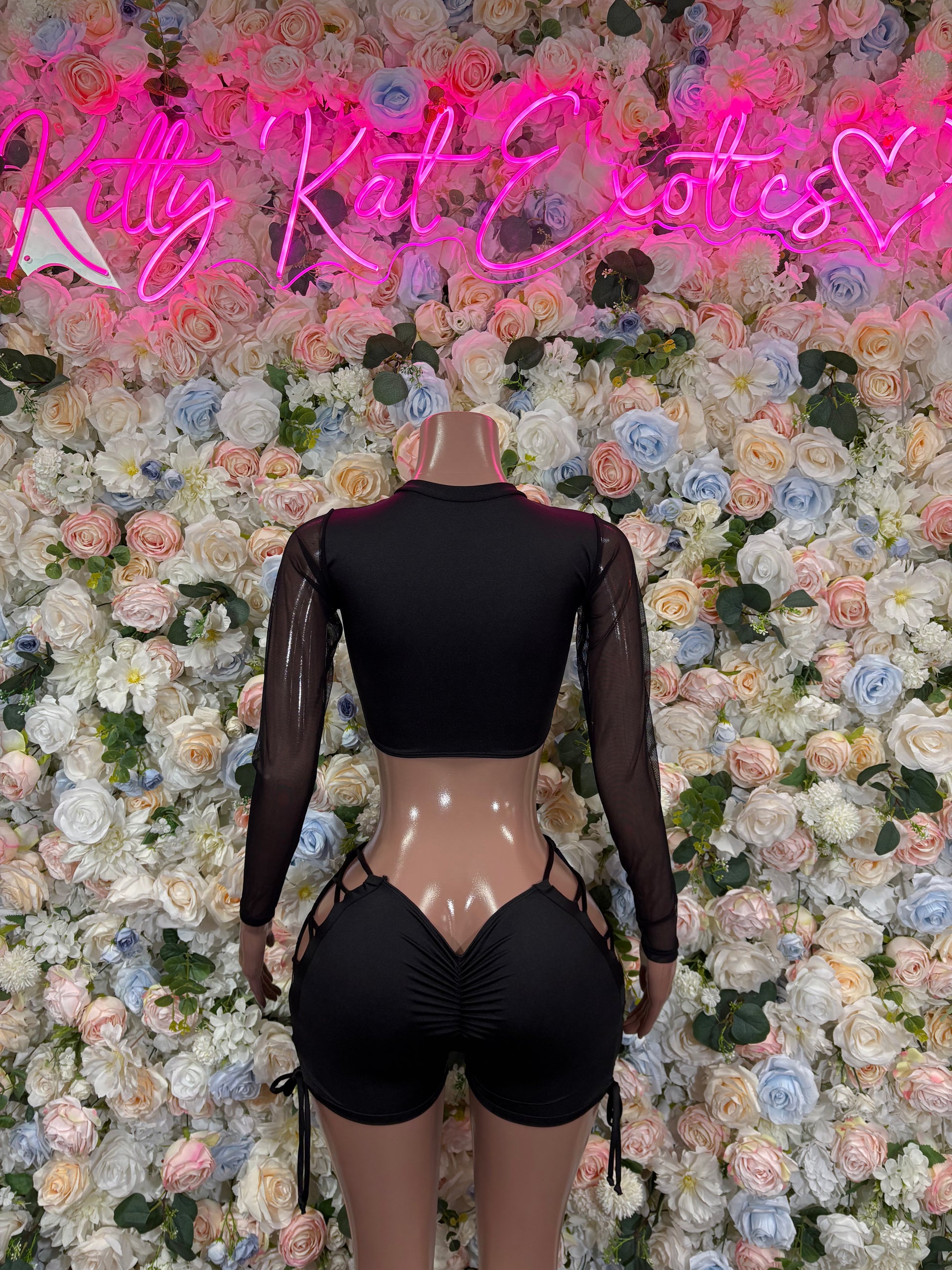 Black lace-back bodysuit with long sleeves and cutout high shorts