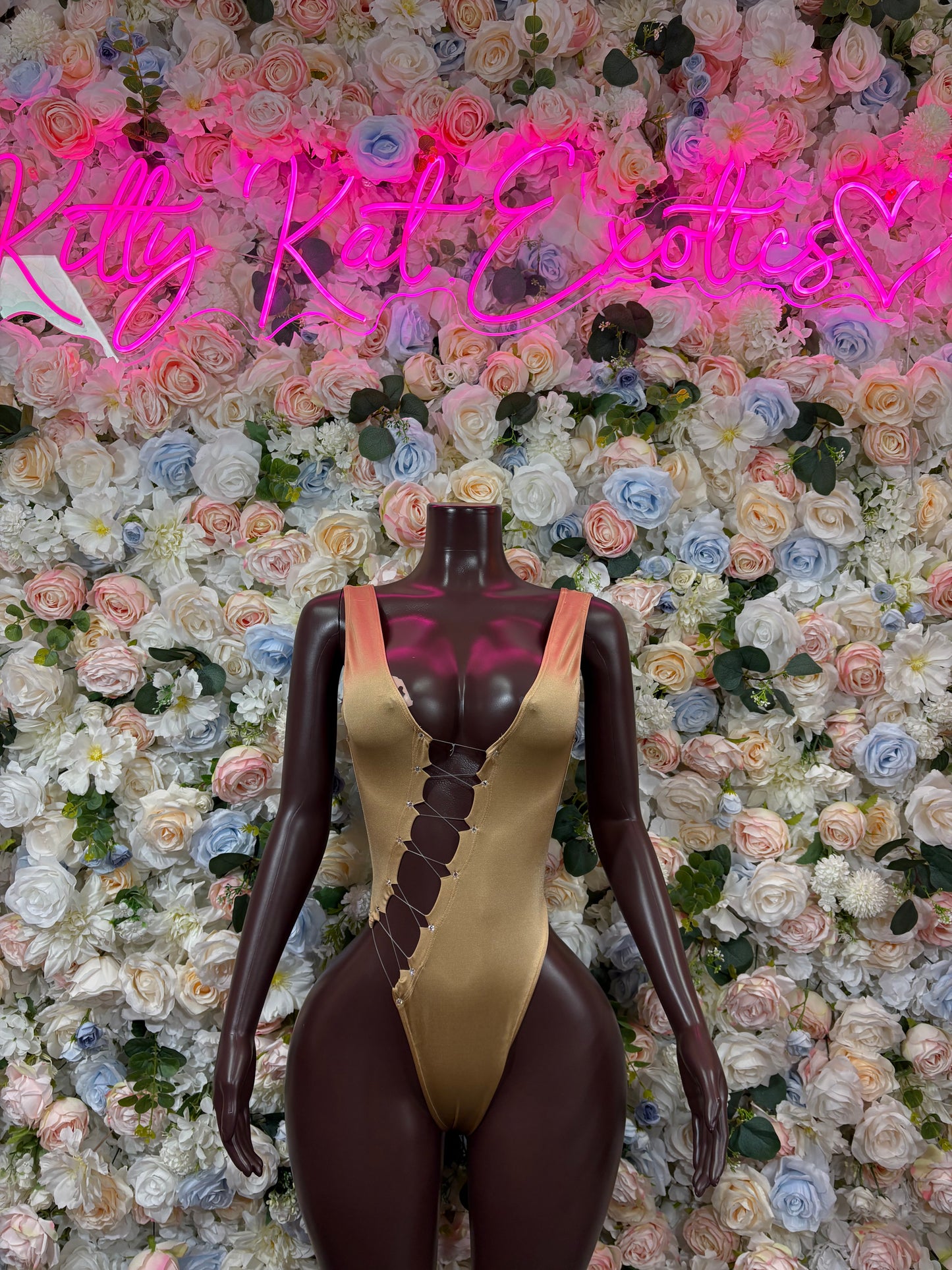 Gold V-neck bodysuit with dark sheer sides, front view