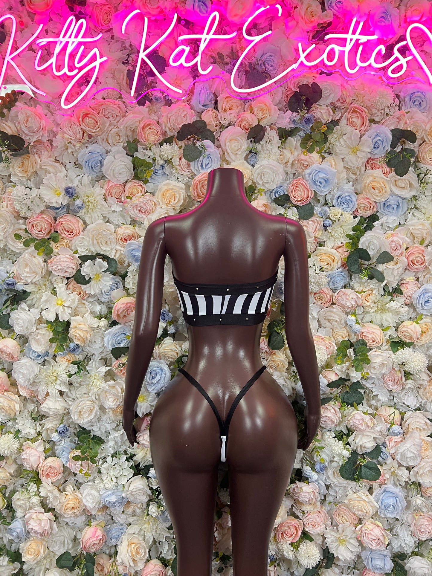Black striped bikini top and thong bottoms, centered on mannequin, front view