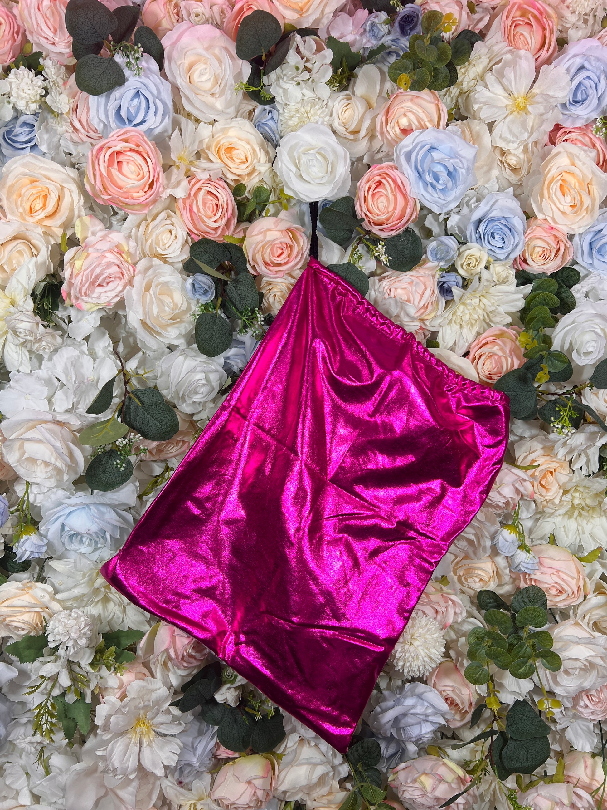 Fuchsia metallic drawstring money bag with glossy sheen and cinched opening