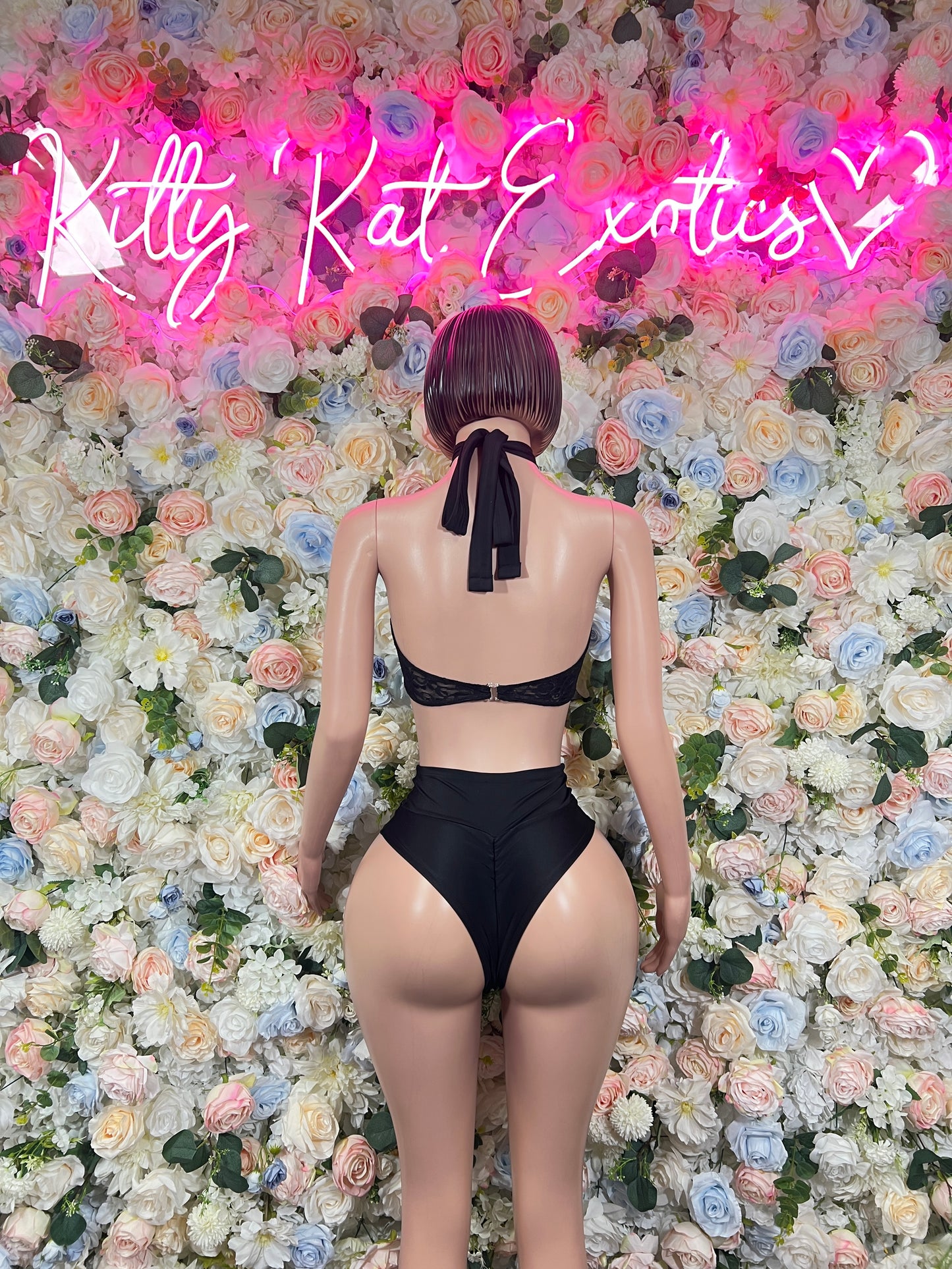 Black two-piece rave outfit back view: halter bra tie and high-leg bottoms
