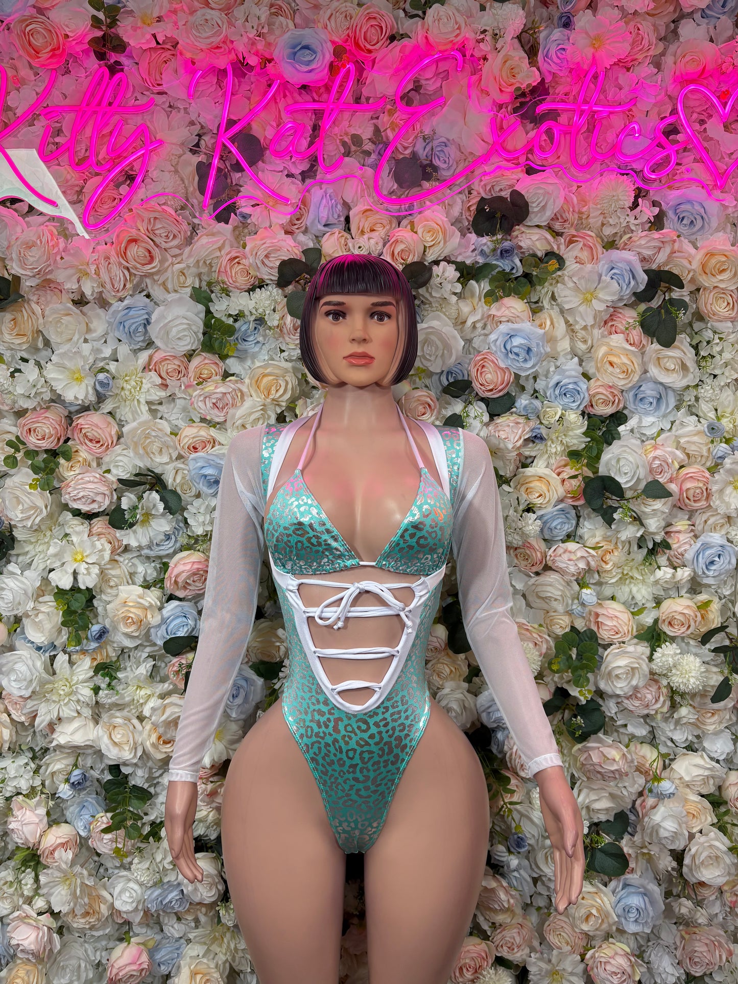 Teal cheetah-print bodysuit with white lace-up front and long sheer sleeves