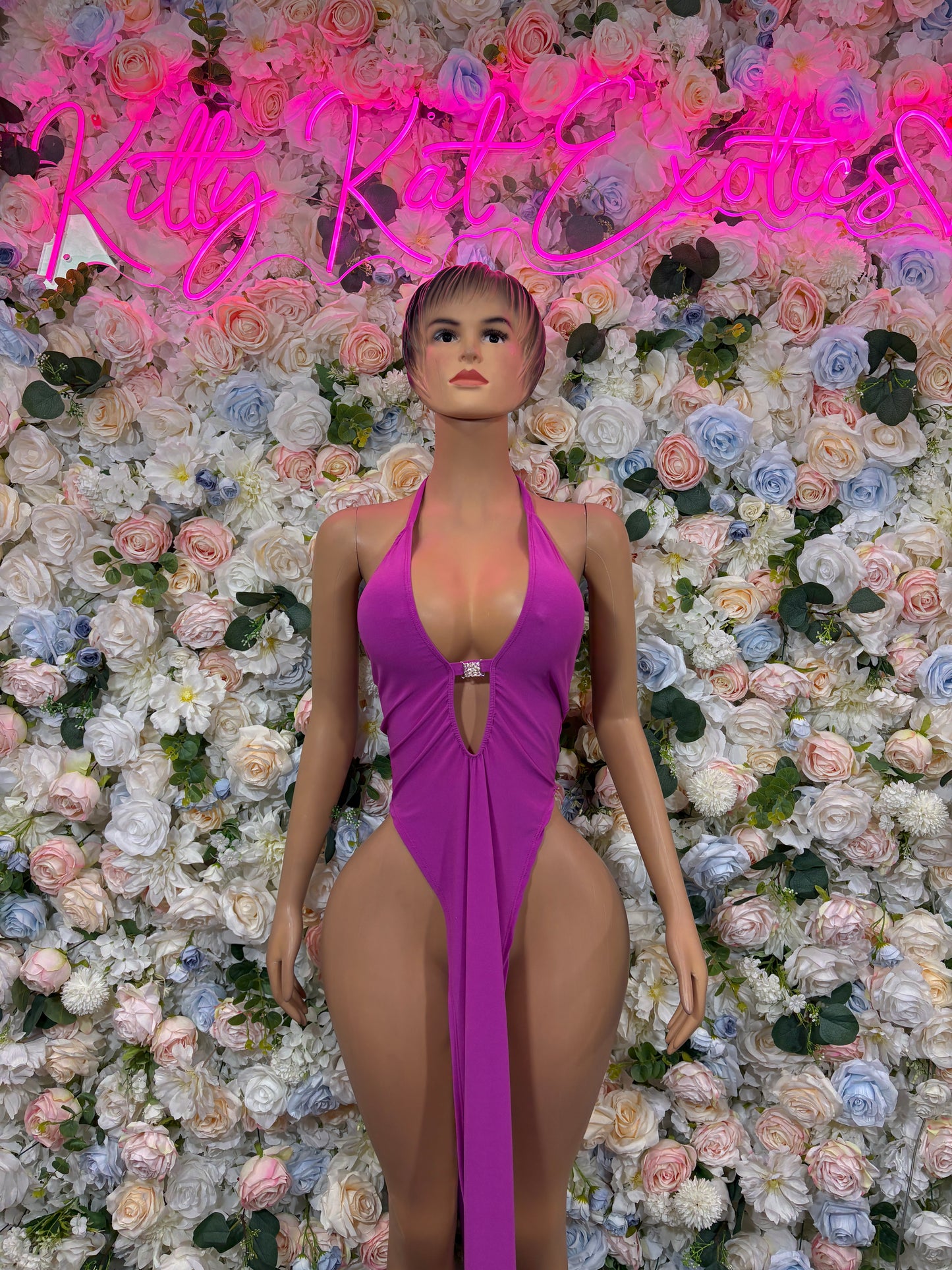 Purple halter rave bodysuit with deep V neckline and side cutouts