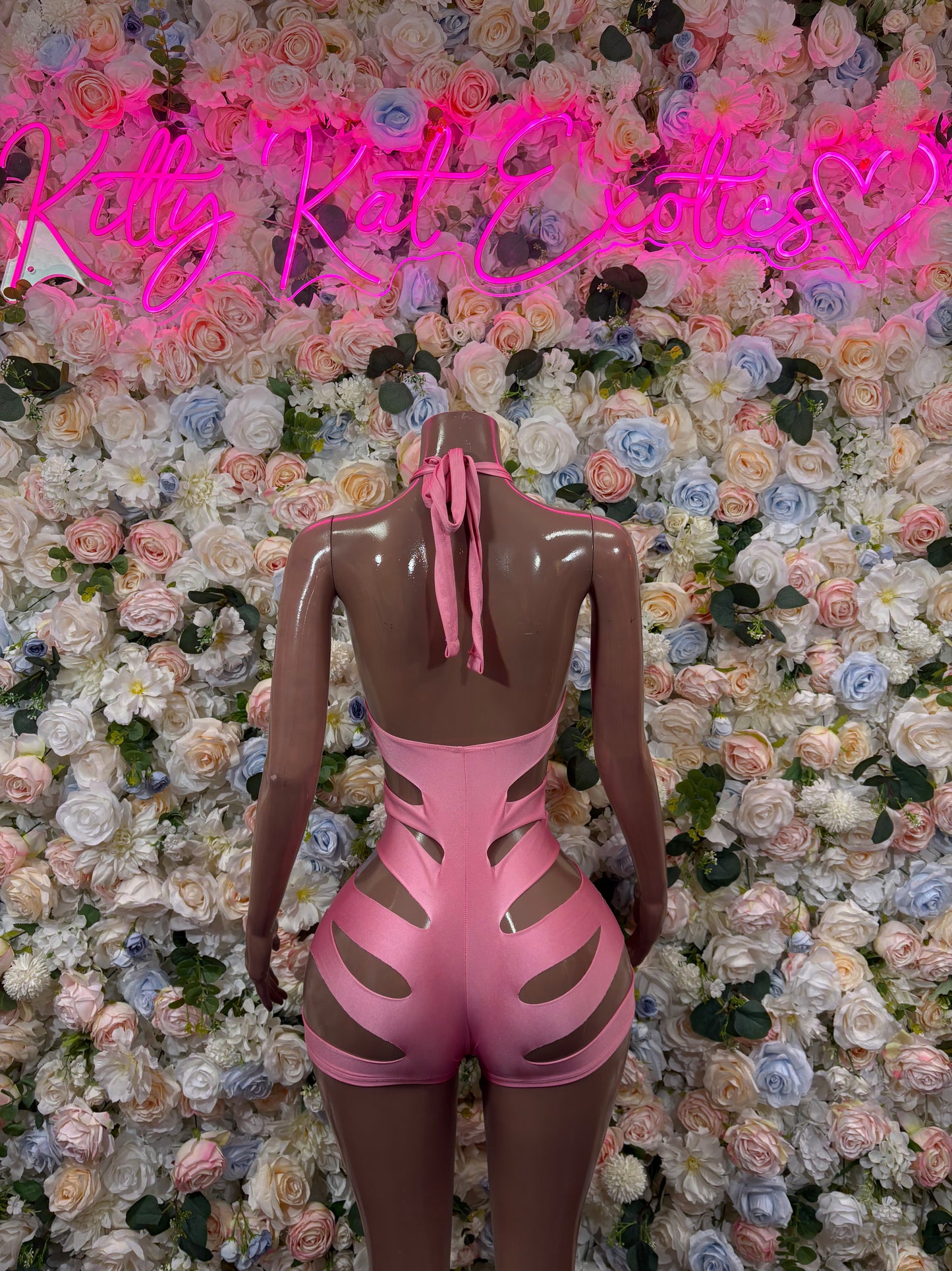 Pink cutout rave bodysuit, back view with ribbon tie and high-cut legs
