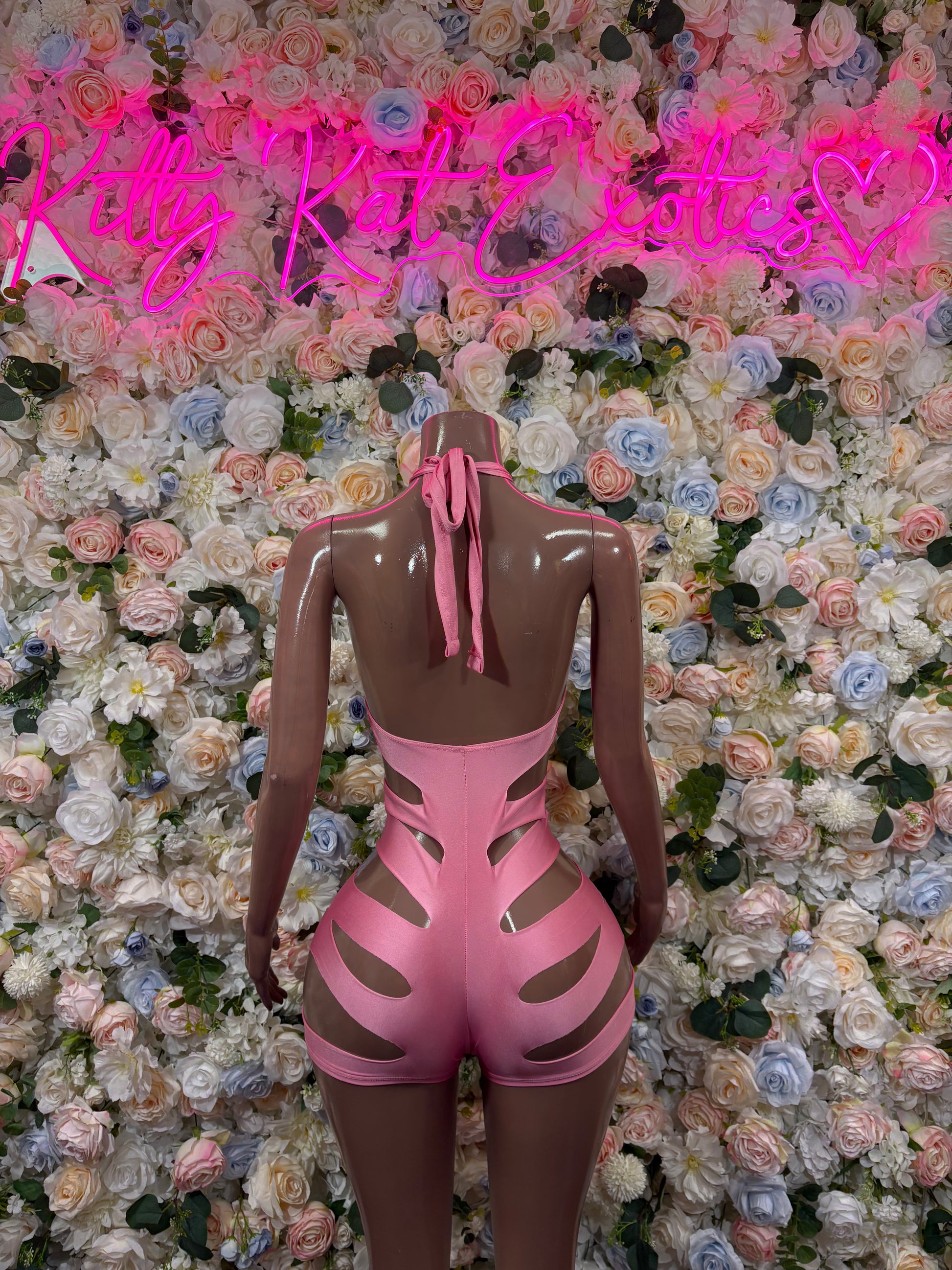Pink cutout rave bodysuit, back view with ribbon tie and high-cut legs