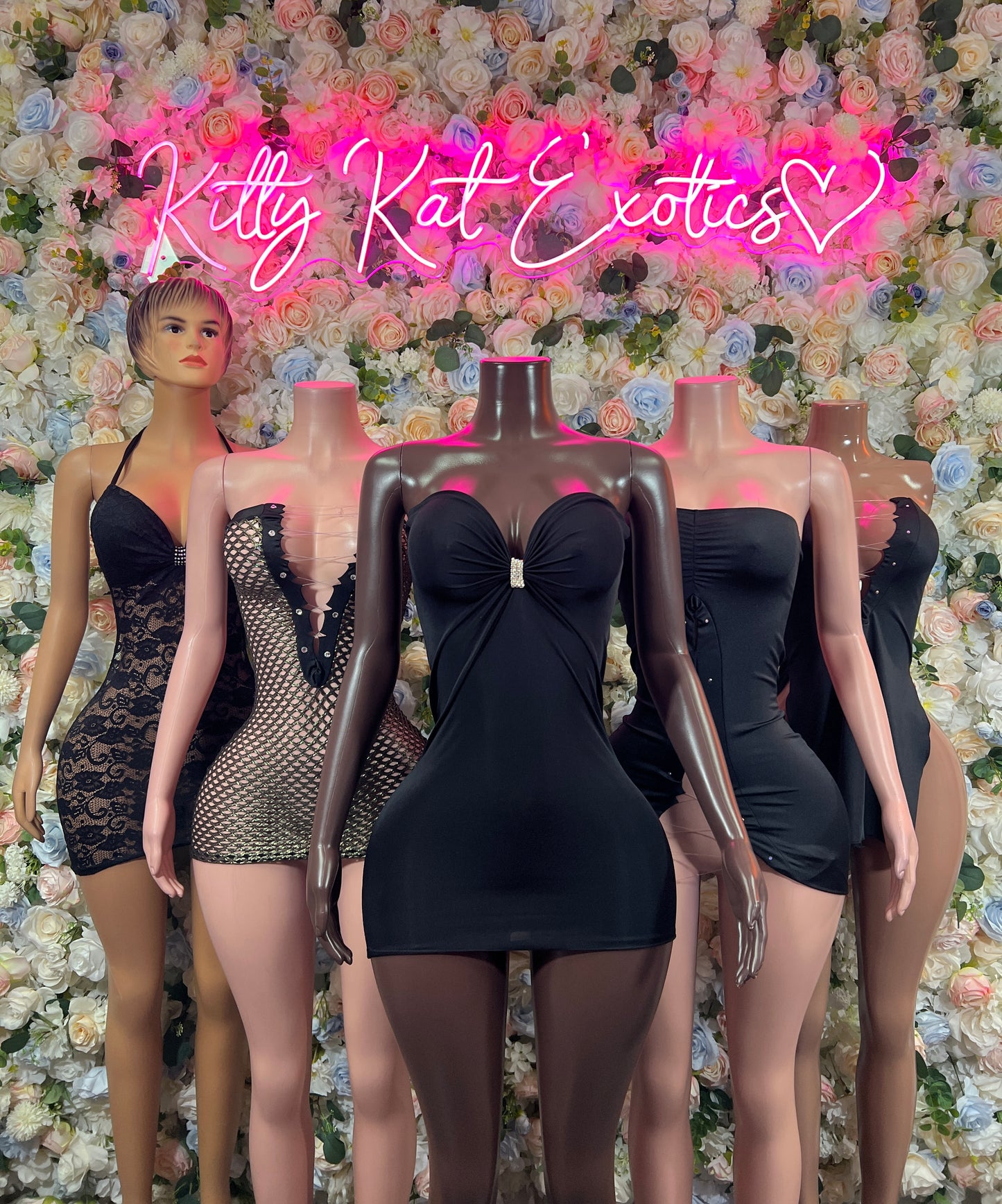 Black mini dress with sweetheart neckline and ruched bow detail at bust