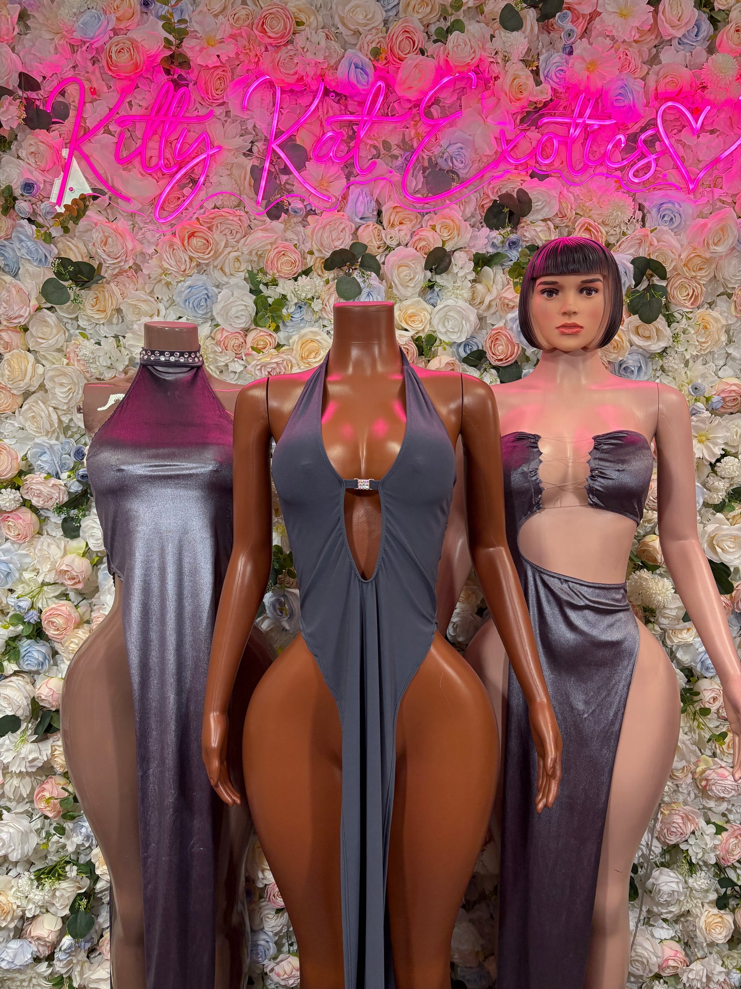 Grey metallic velvet halter gown on mannequin with sleeveless fitted silhouette