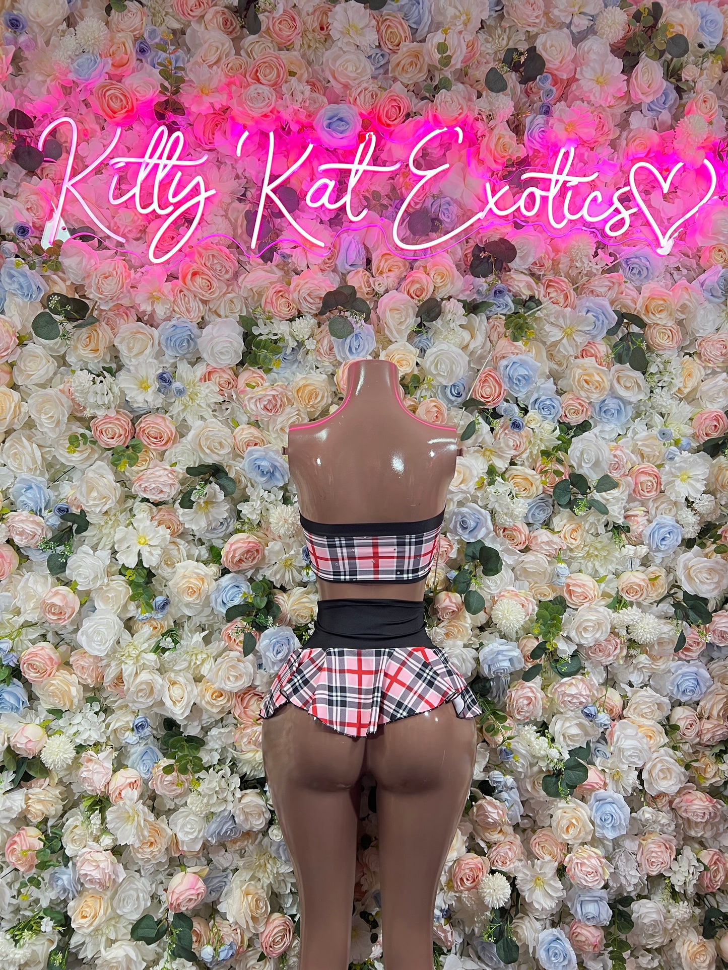 Pink plaid two-piece skirt set with bow halter top and flared pleated skirt, black trim