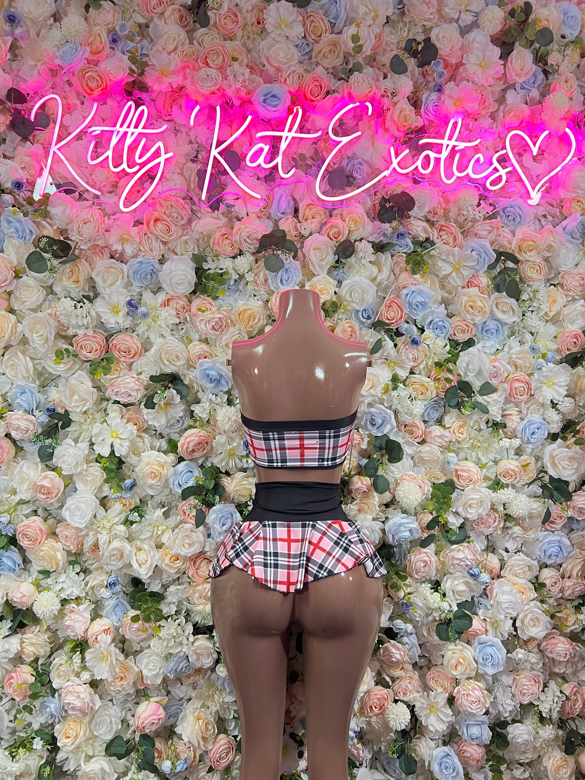Pink plaid two-piece skirt set with bow halter top and flared pleated skirt, black trim