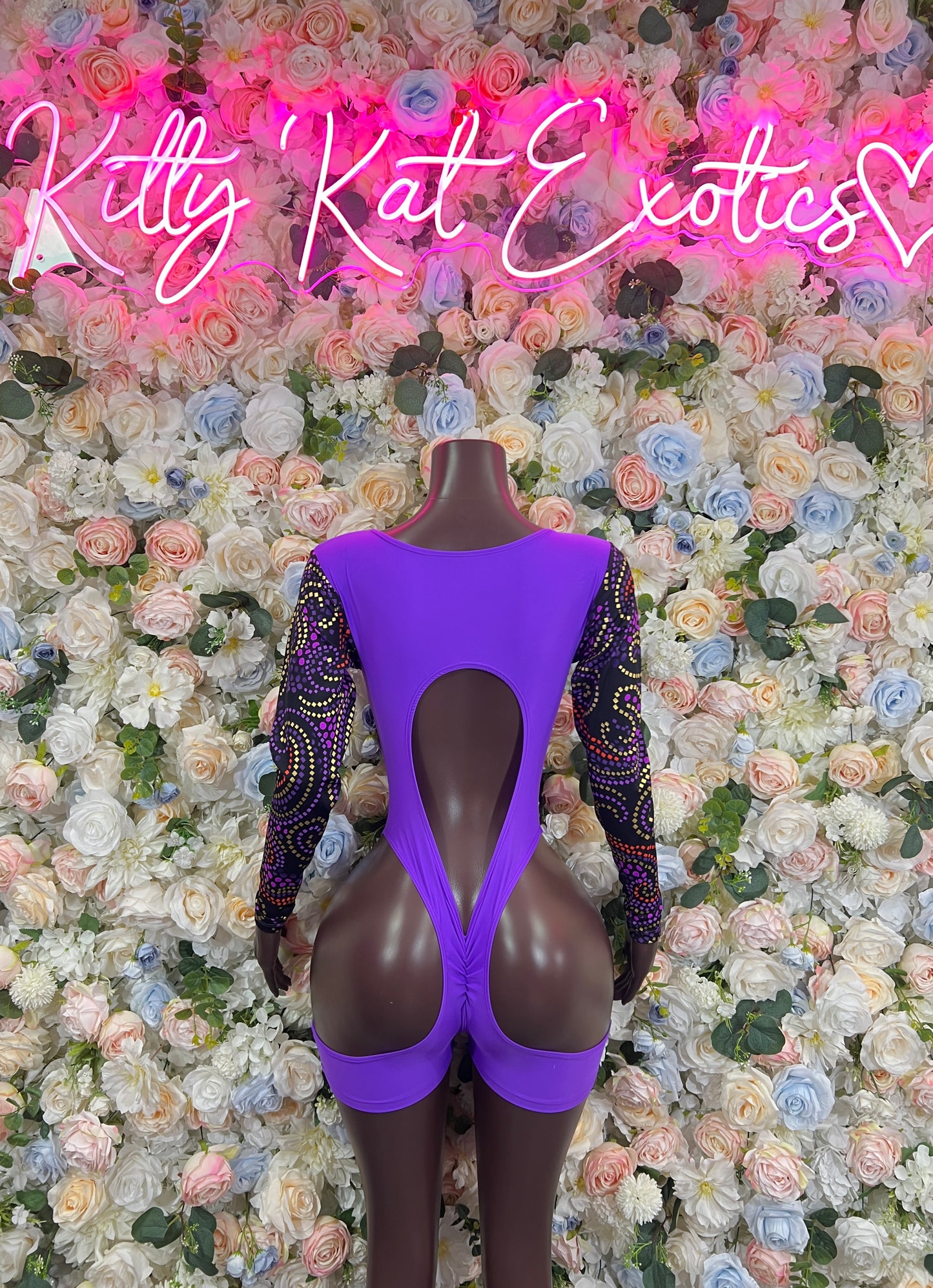 Purple open-back bodysuit with long sleeves and deep teardrop cutout
