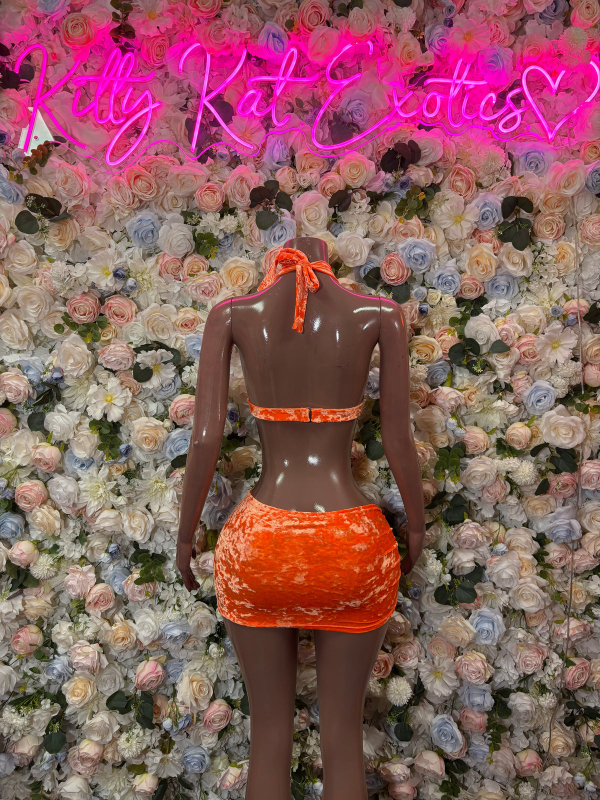 Orange halter two-piece dancewear set with ruched mini skirt, back view