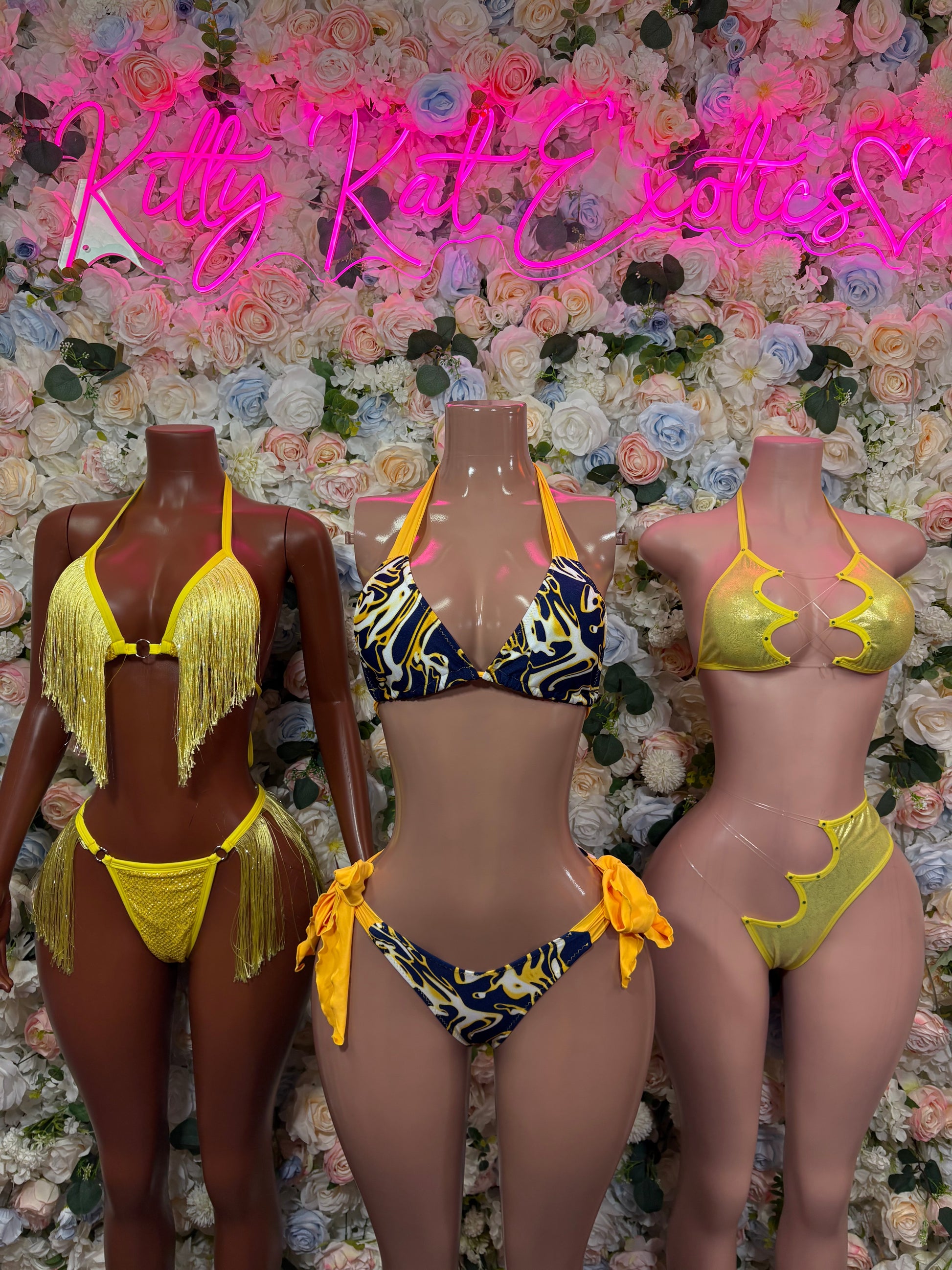 Two-piece lingerie set on three mannequins: yellow fringe and patterned bikini styles