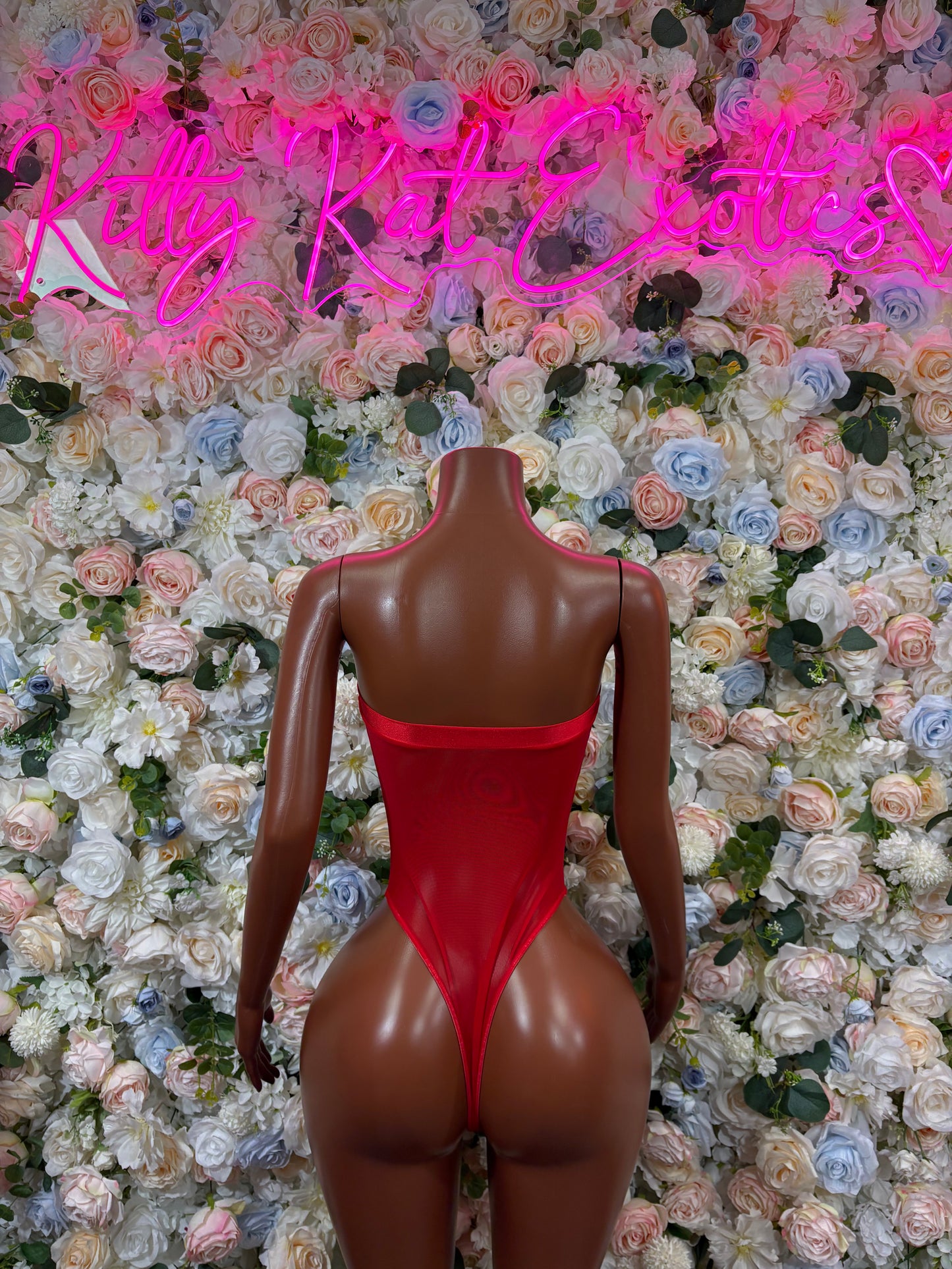 Red high-cut bodysuit back view with V-shaped back on mannequin