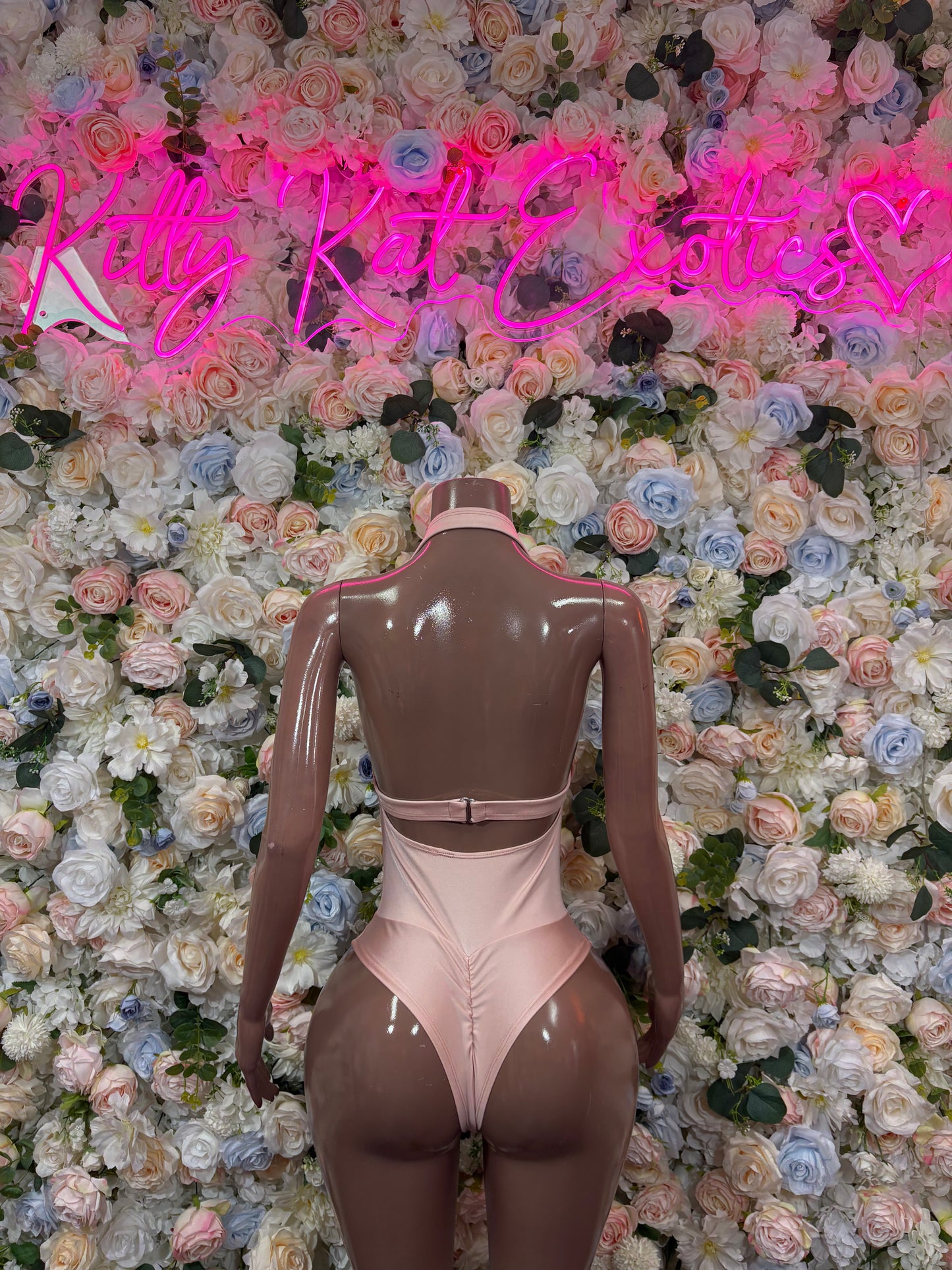 Nude bodysuit back view with high neck, cutout waistband, and open back