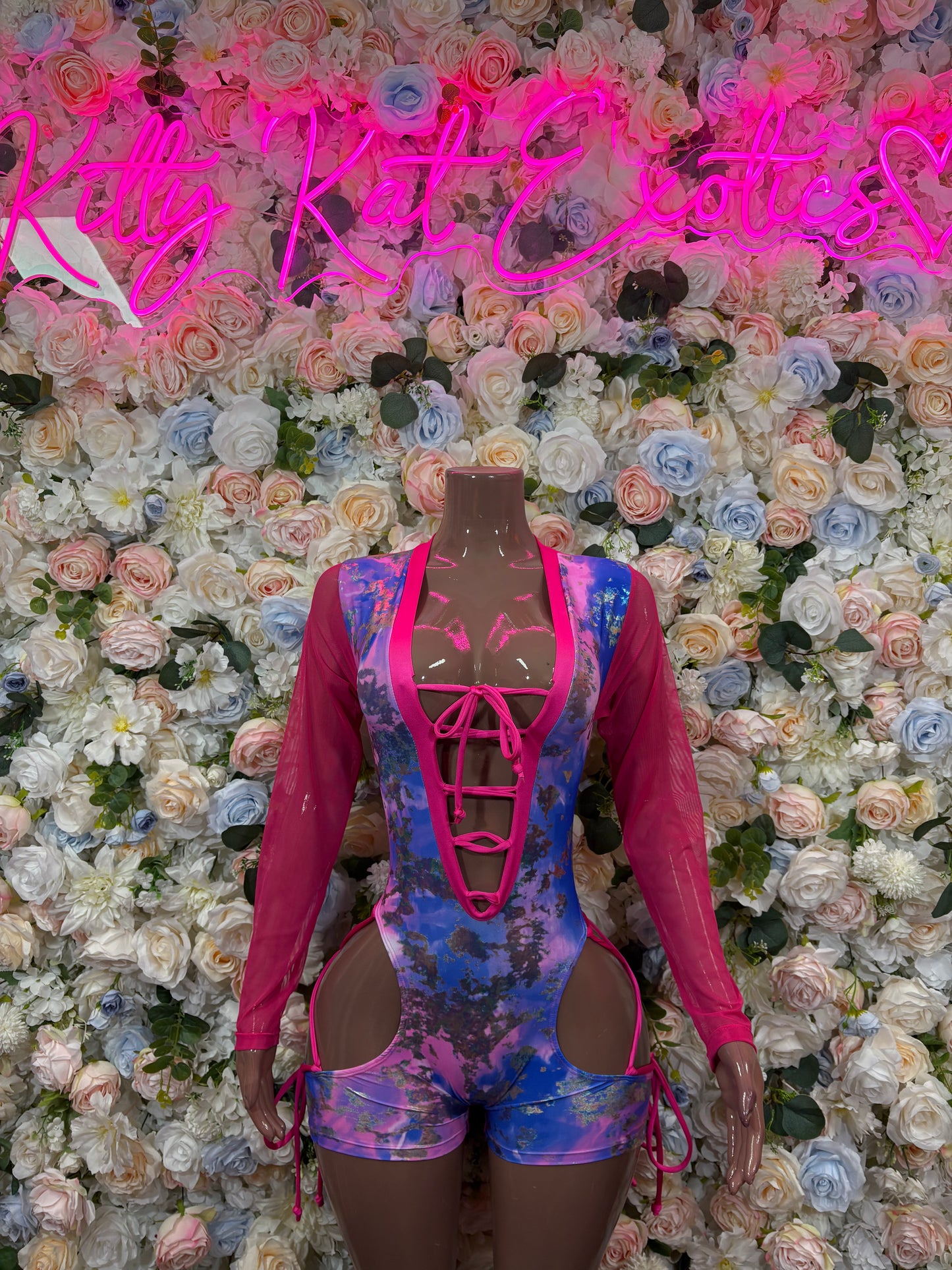 Pink and blue metallic bodysuit with long sleeves, front lace-up straps and cutout