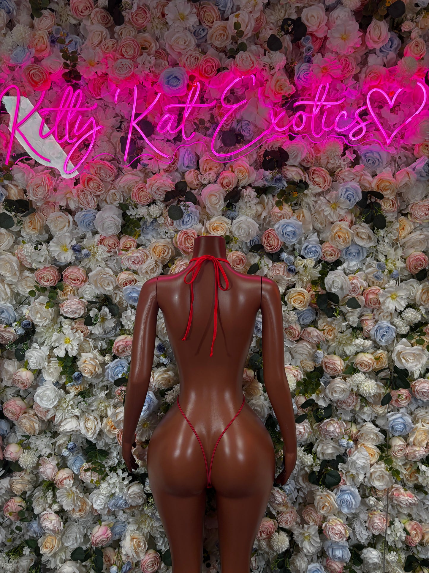 Red fishnet slingshot bodysuit, back view with crisscross strap ties