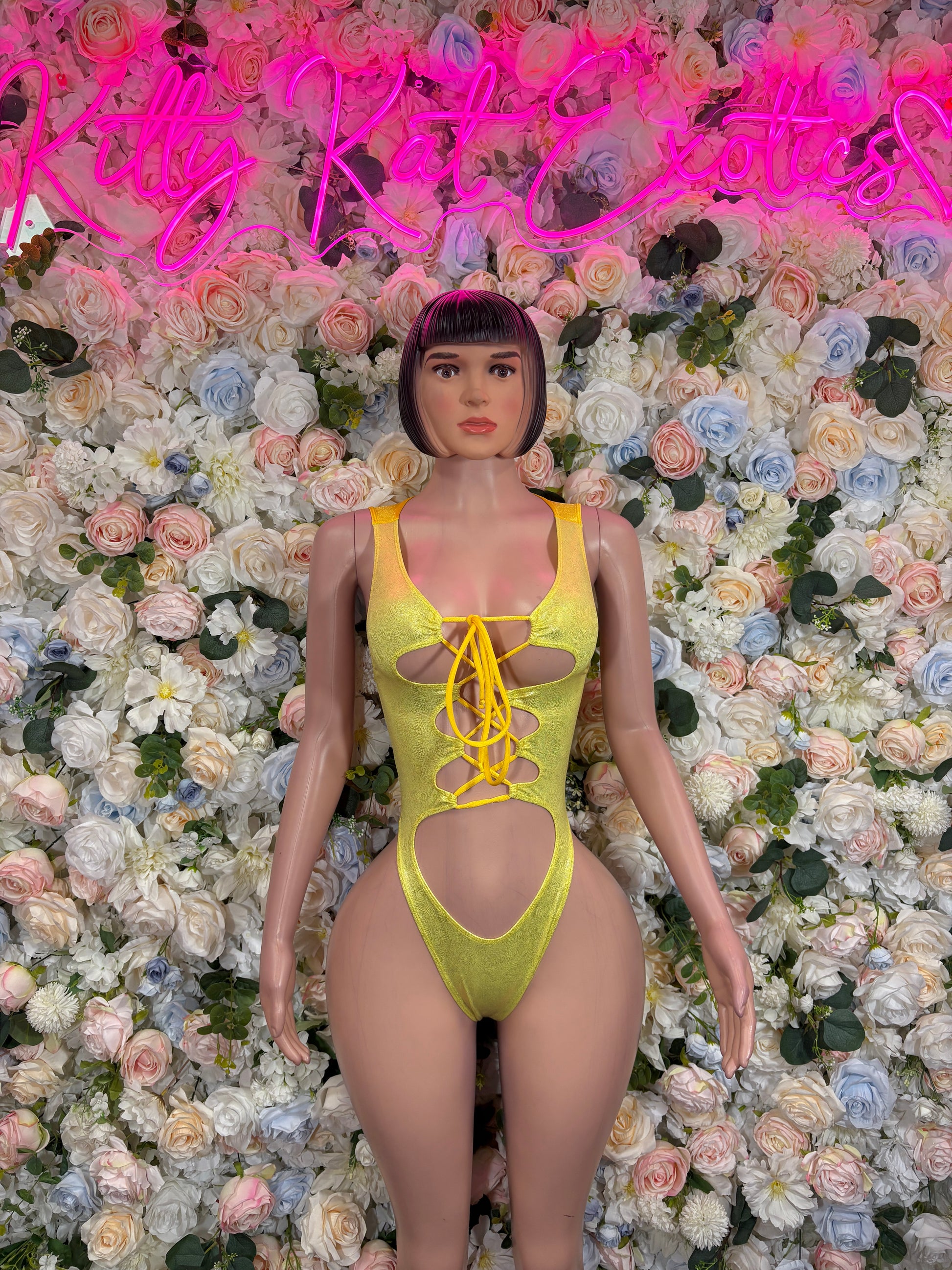Yellow metallic bodysuit with lace-up front, thin straps, and heart-shaped chest cutout