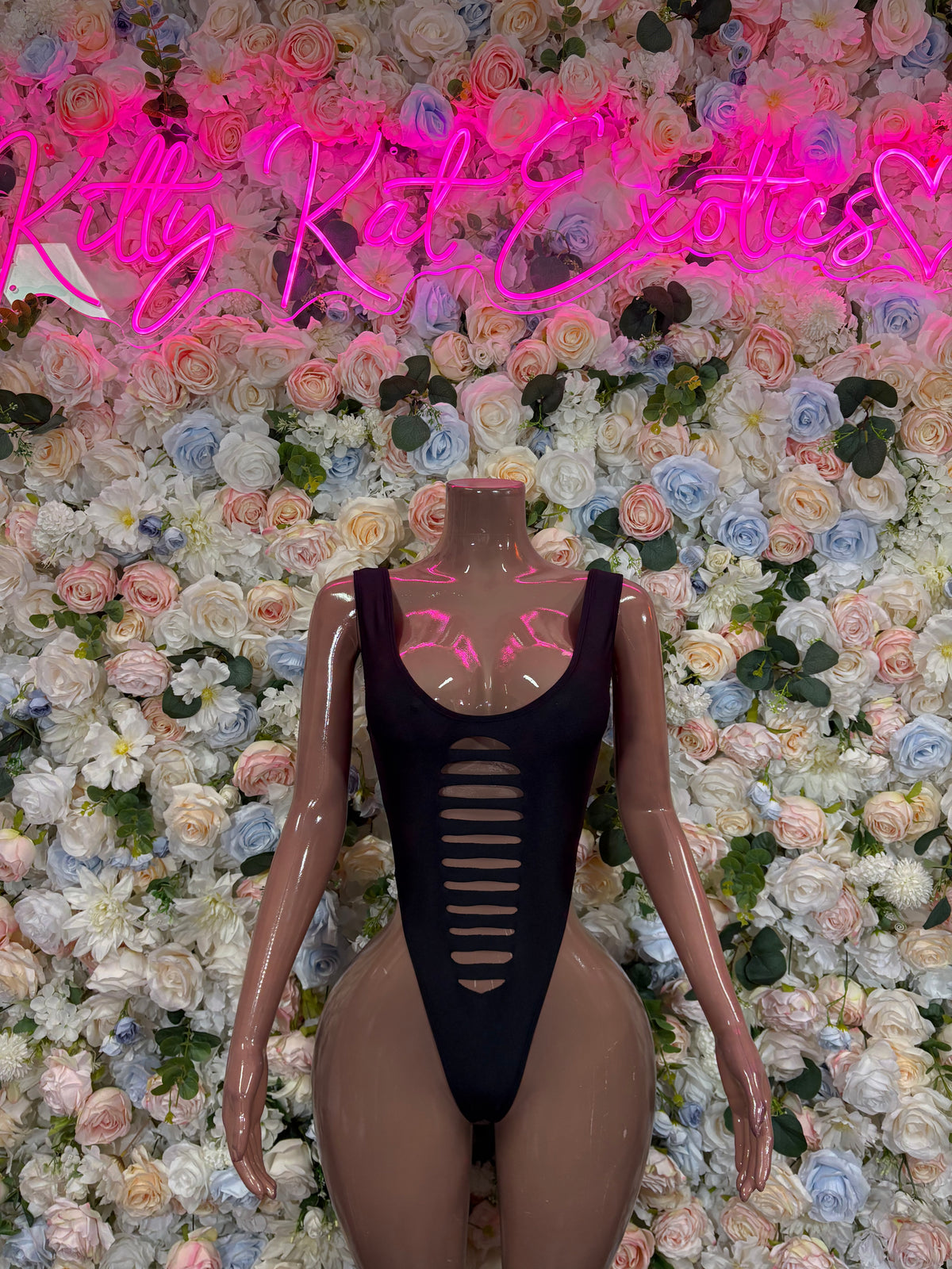 Black bodysuit with center chest cutout and vertical ribbed front opening