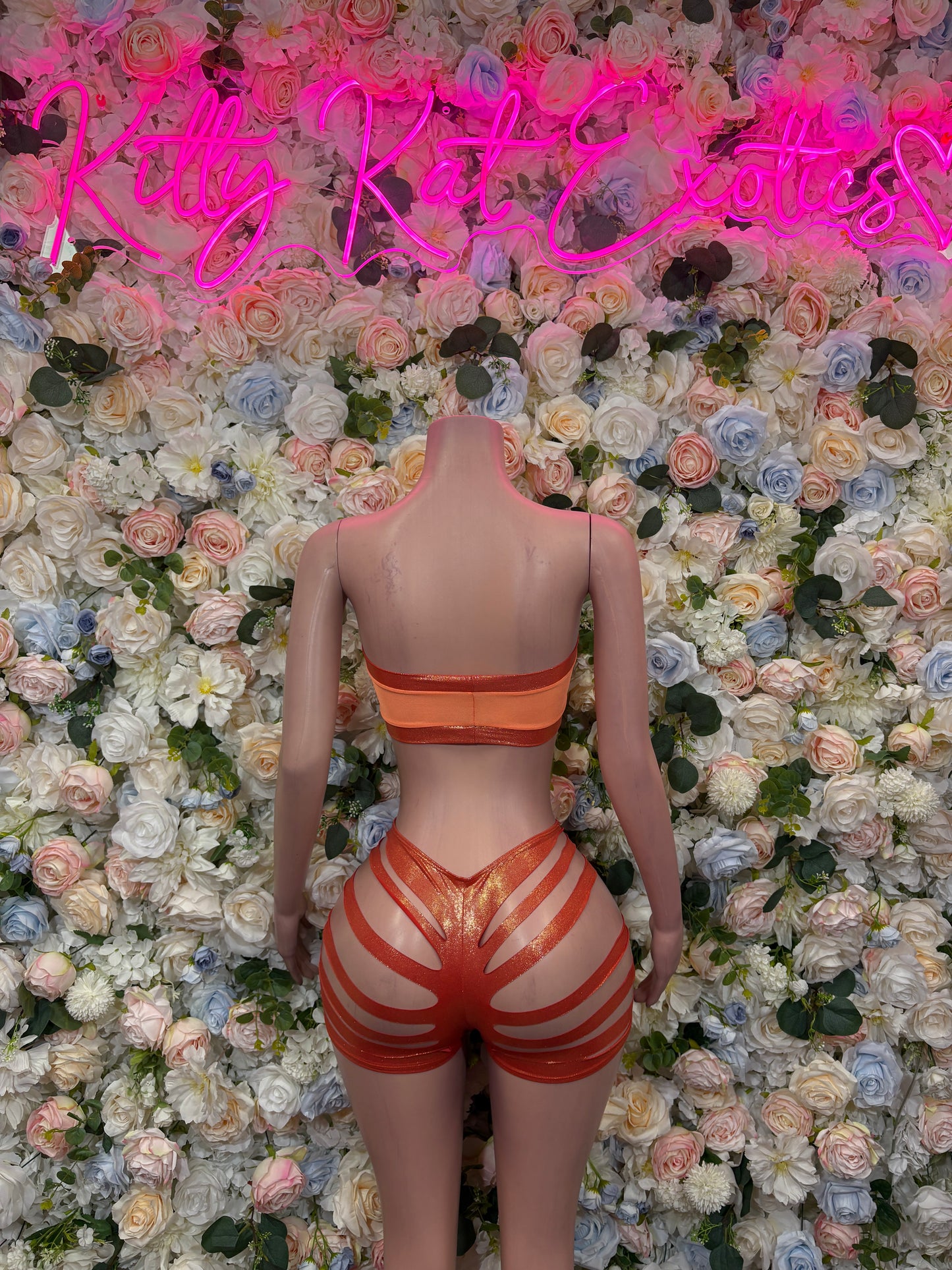 Orange bandeau crop top and striped high-waist shorts, front view