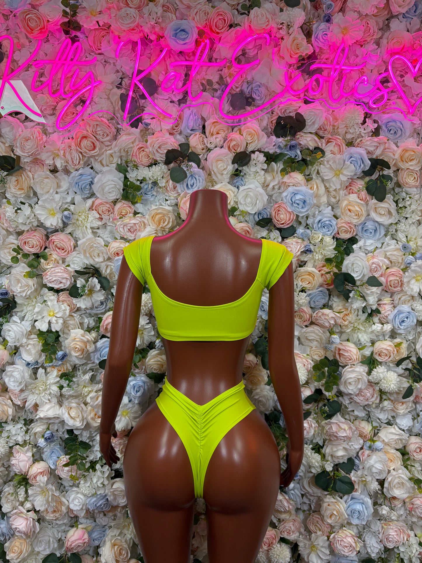 Neon green rave two-piece: backless halter crop top and high-cut bikini briefs