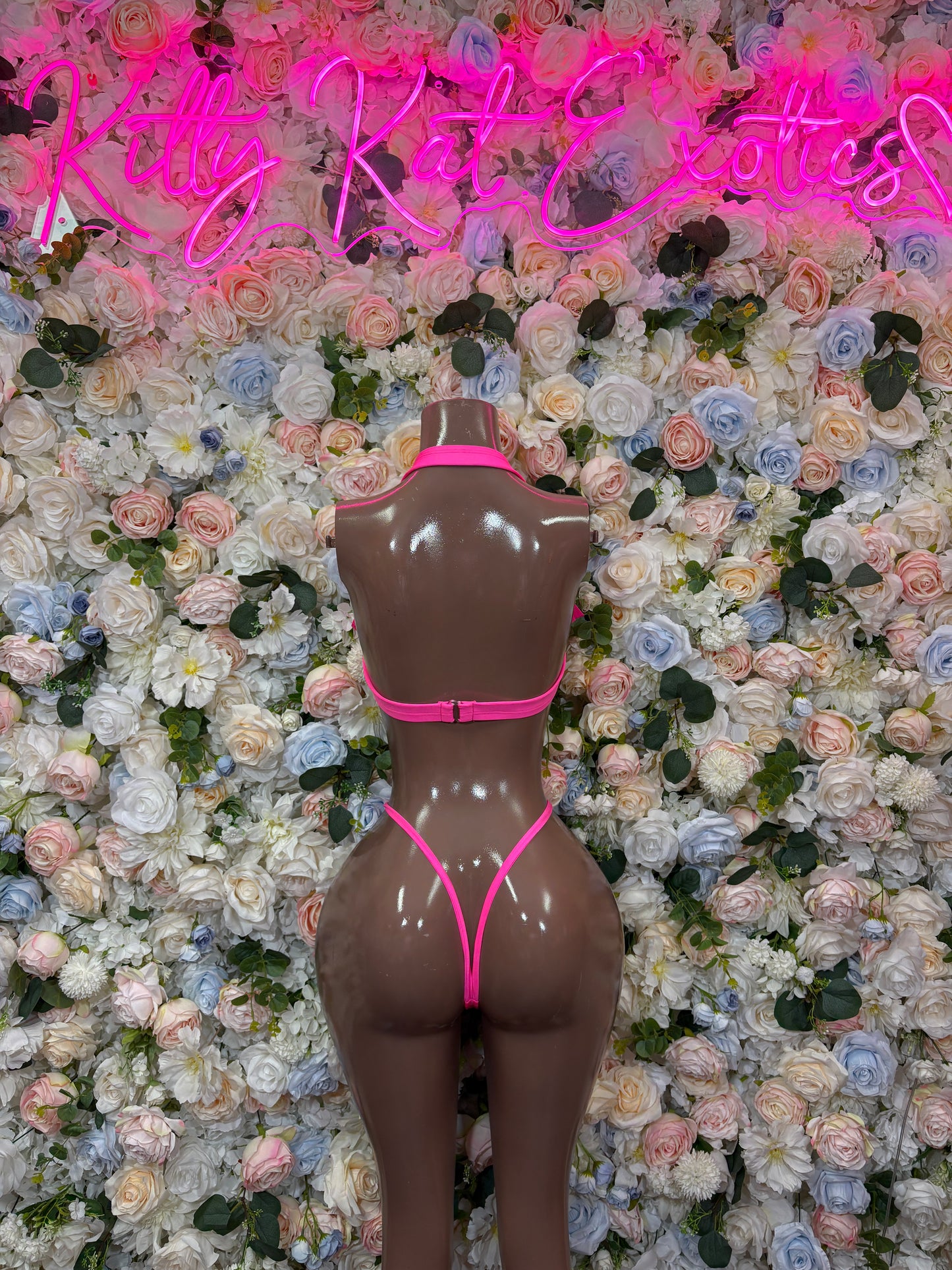 Pink two-piece rave wear set, back view with triangle top and V-string bottoms