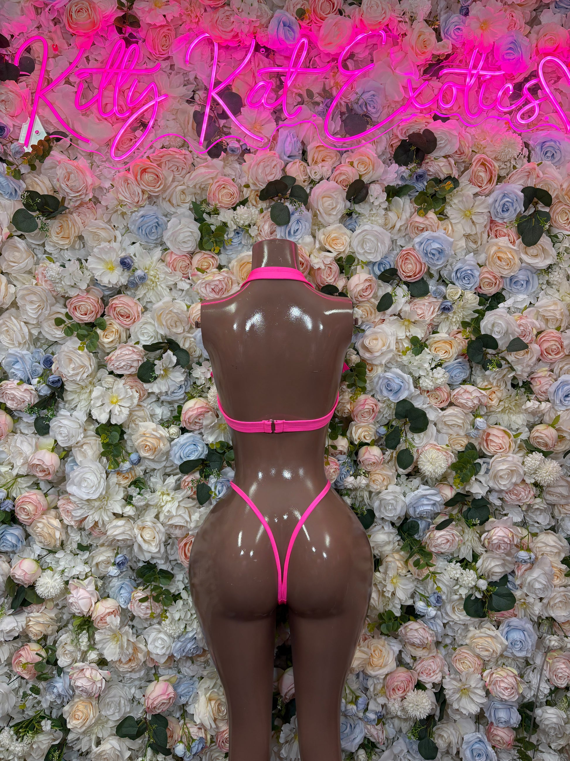 Pink two-piece rave wear set, back view with triangle top and V-string bottoms