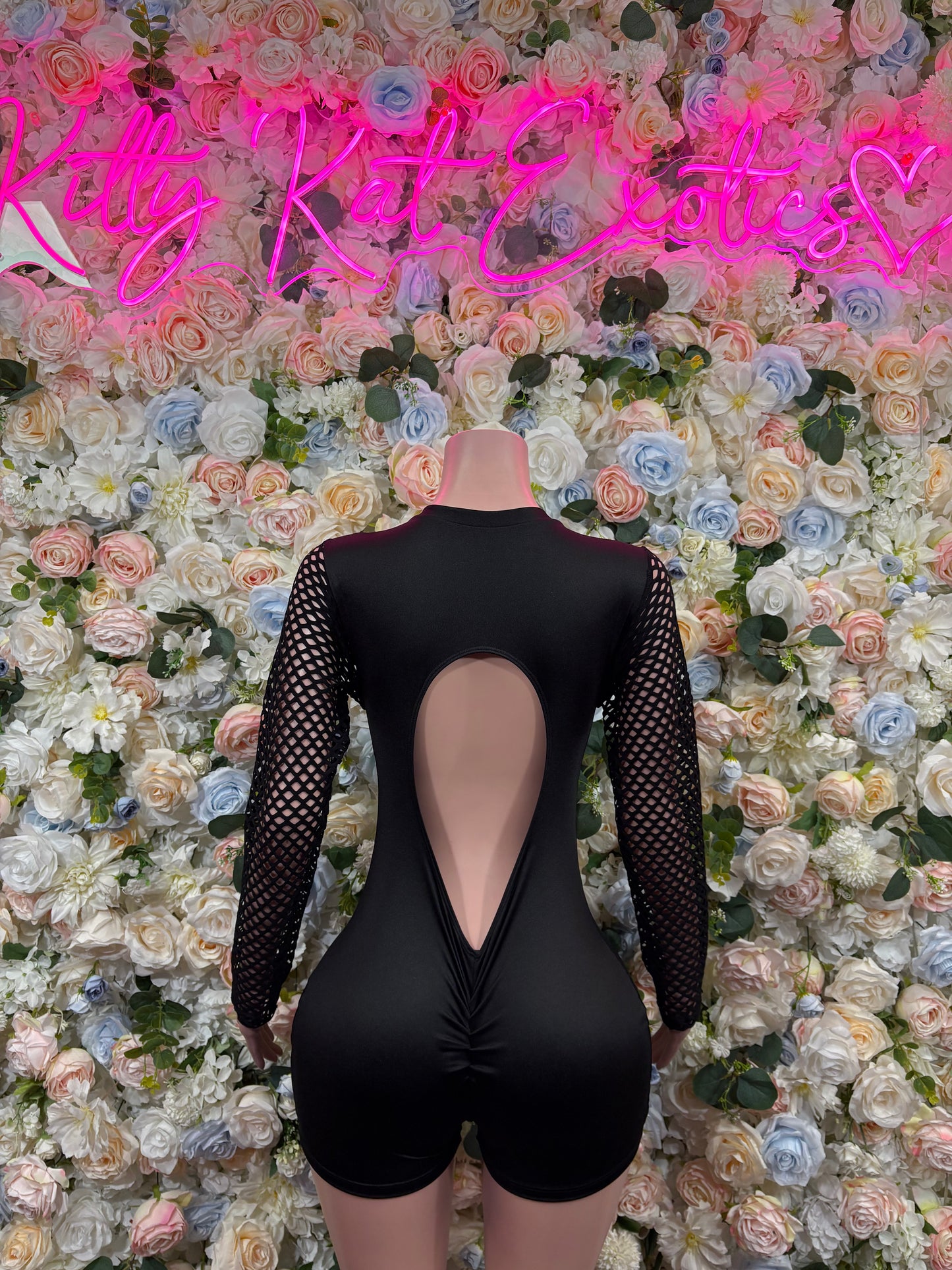 Black one-piece bodysuit with mesh long sleeves and teardrop back cutout
