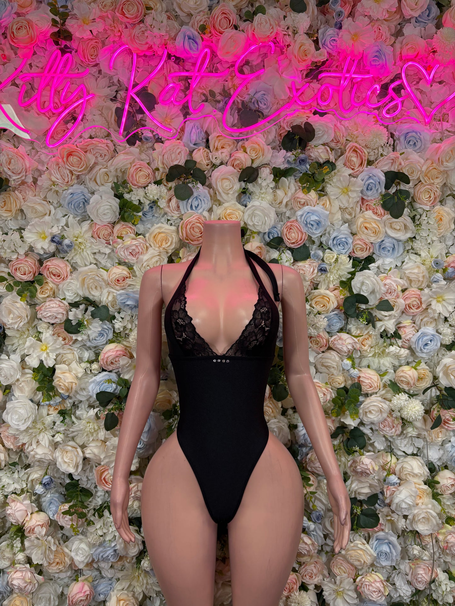 Black lace-trim one-piece bodysuit with halter straps and high-cut legs