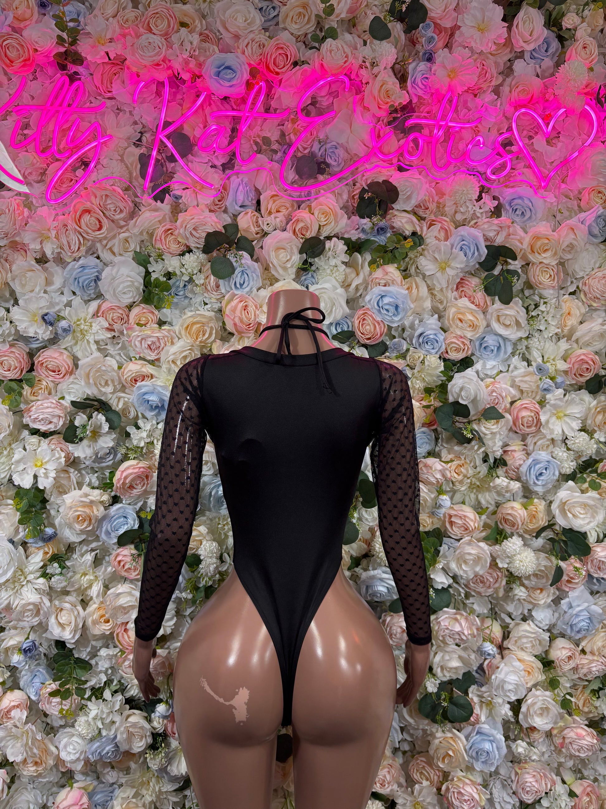Black mesh bodysuit with long sleeves, heart pattern, high-leg cutout front