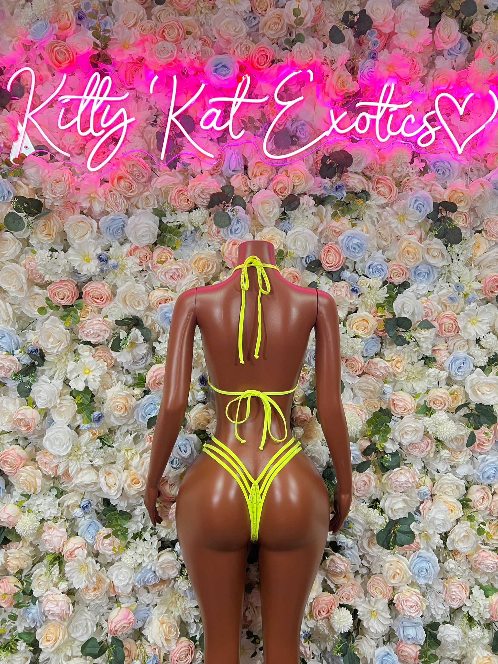 Neon green rhinestone bikini set back view with cross straps and tied halter top on mannequin