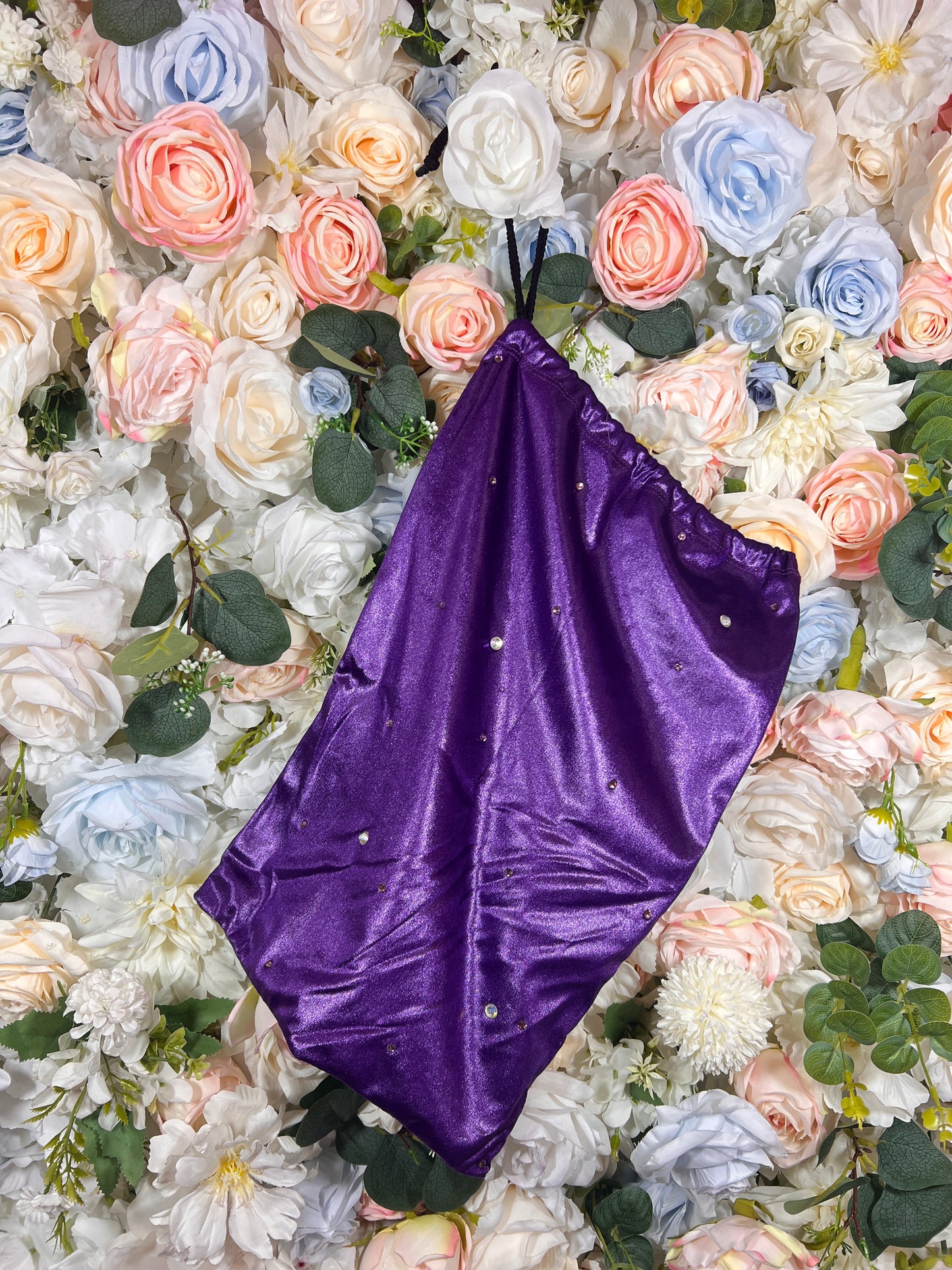 Purple velvet money bag with black handles and small metallic dots
