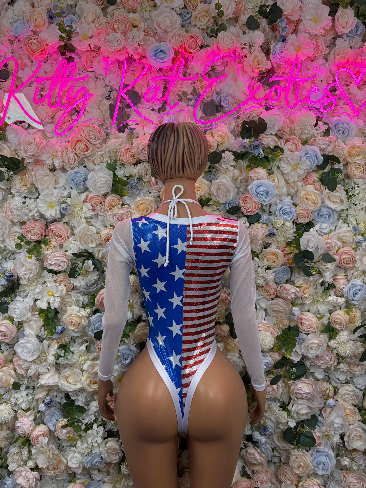 American flag bodysuit back view with star-and-stripe print and lace-up tie back, sheer sleeves