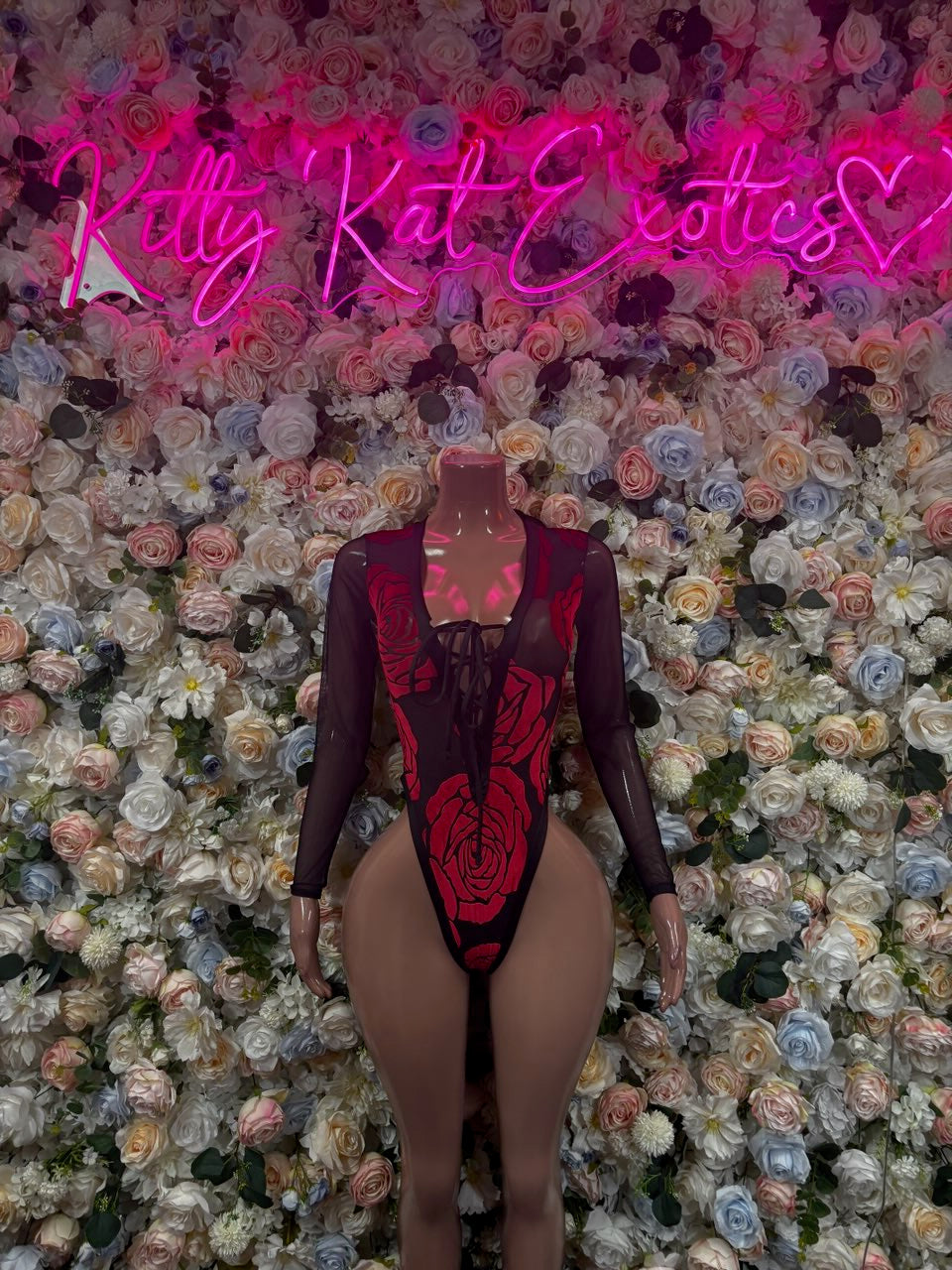 Black long-sleeve bodysuit with red graphic print and lace-up front cutout