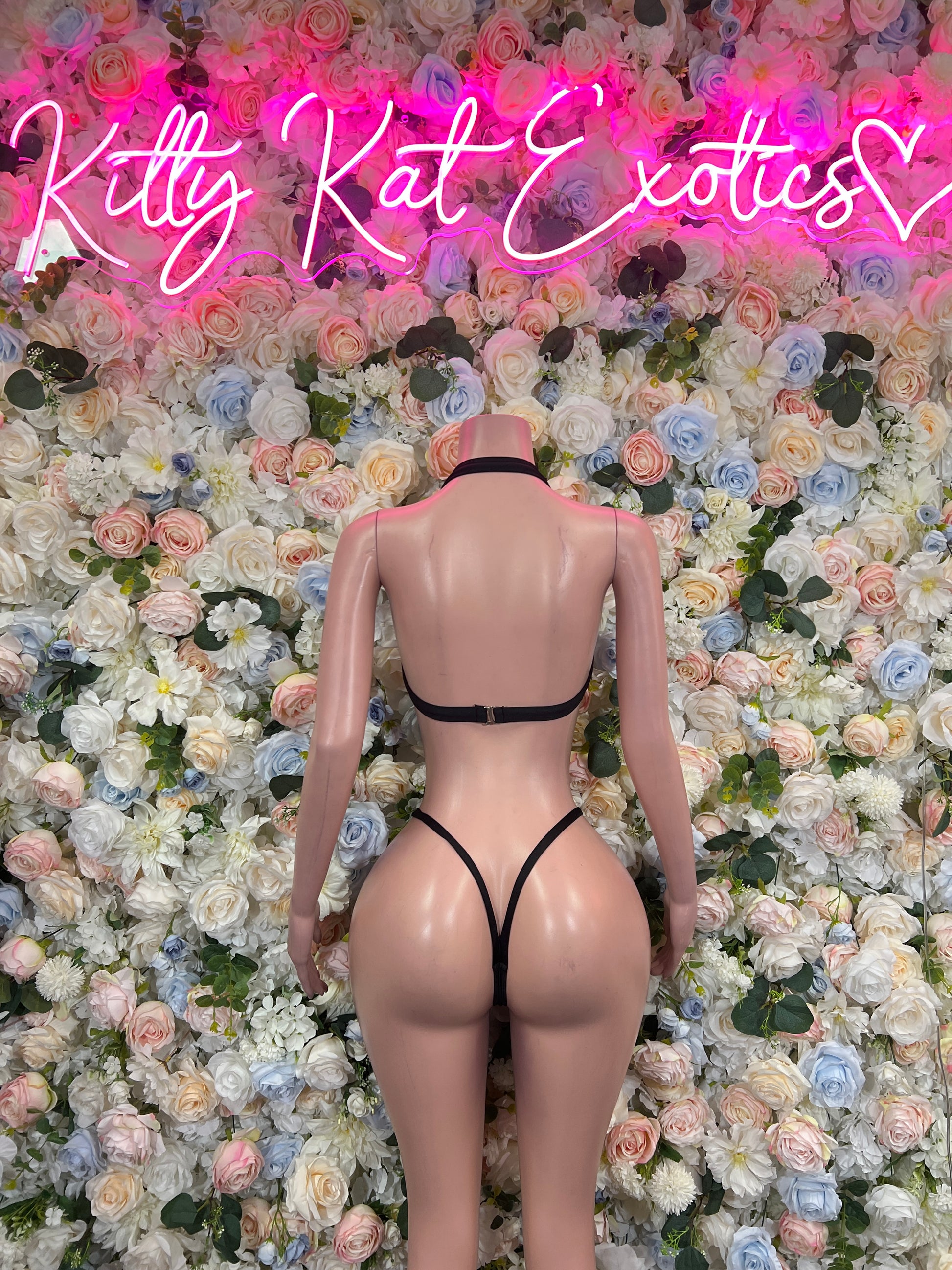 Back view of black bikini with white striped cups and crisscross back thong