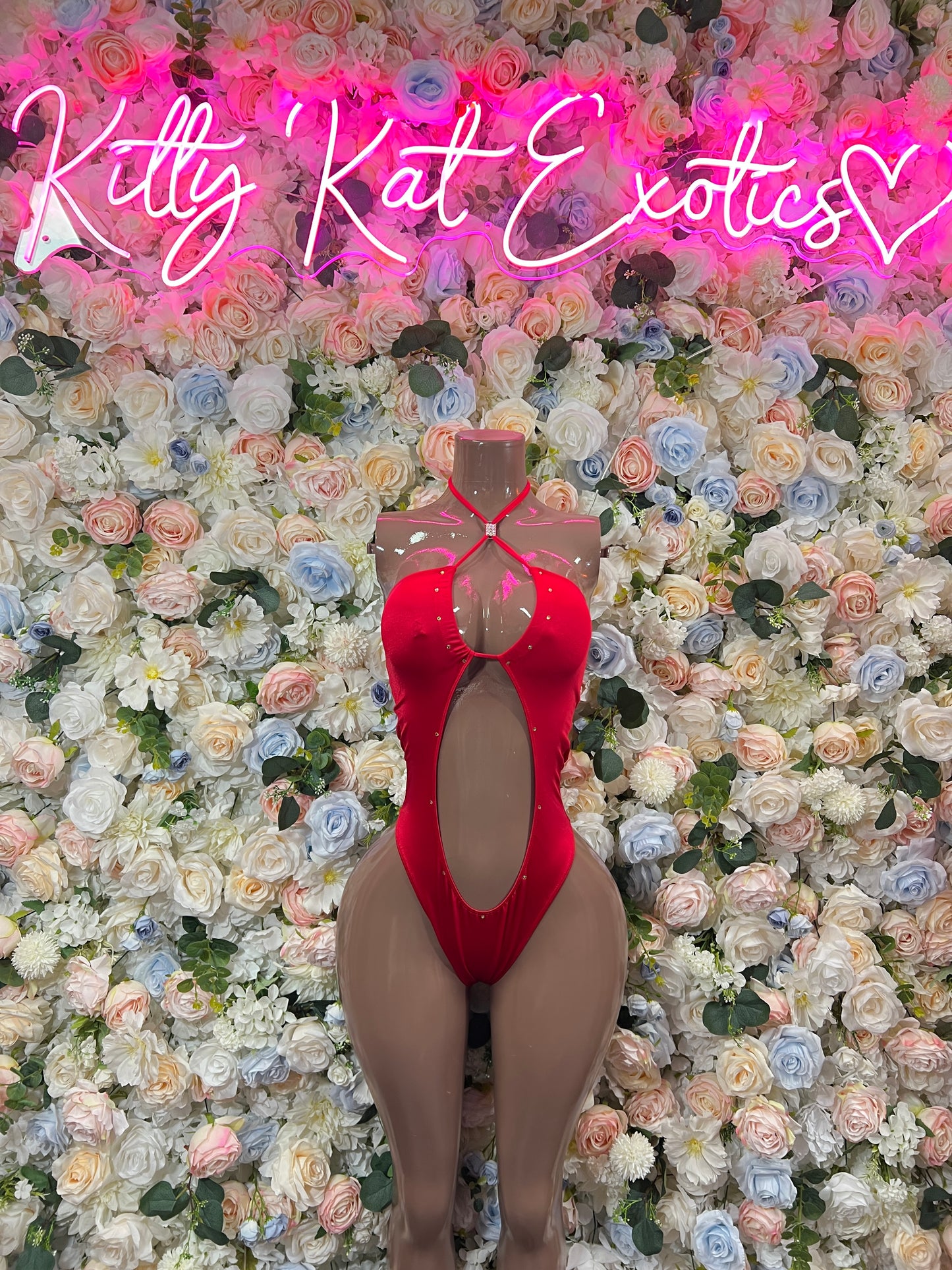 Red halter bodysuit with open back and oval cutout, thong-style bottom