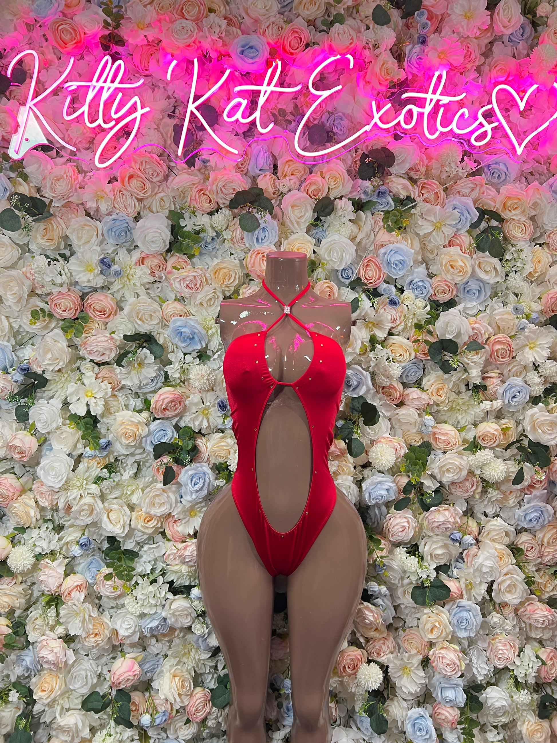 Red halter bodysuit with open back and oval cutout, thong-style bottom