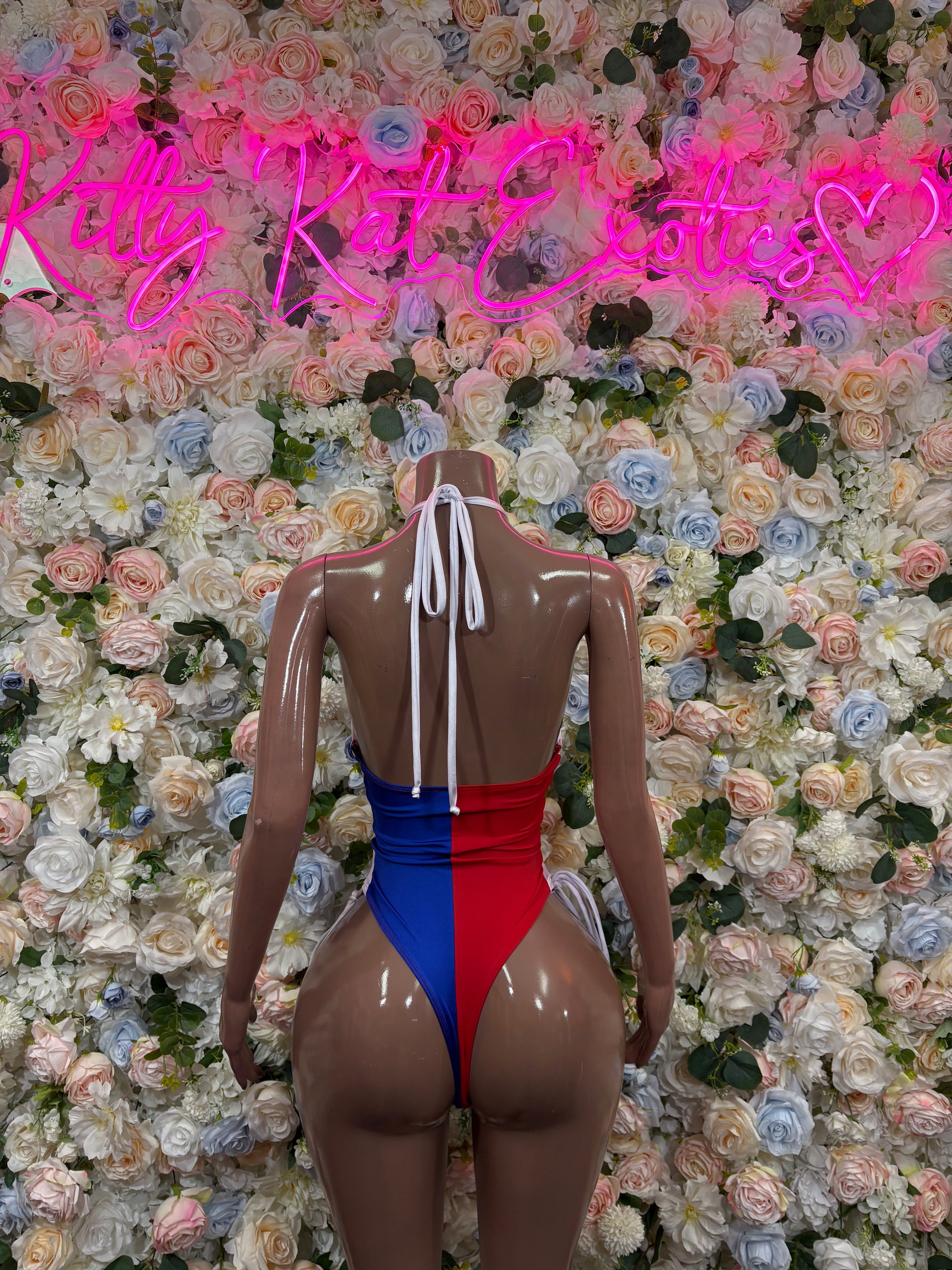 Backless Dominican flag bodysuit in blue, red, and white with lace-up shoulder straps.