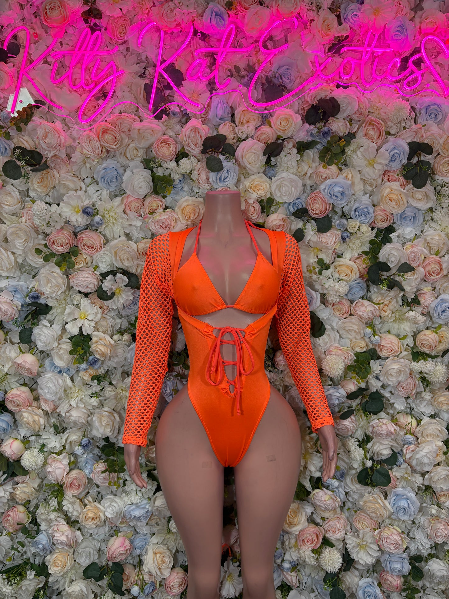 Orange halter one-piece bodysuit with fishnet sleeves, lace-up neckline, high-cut legs