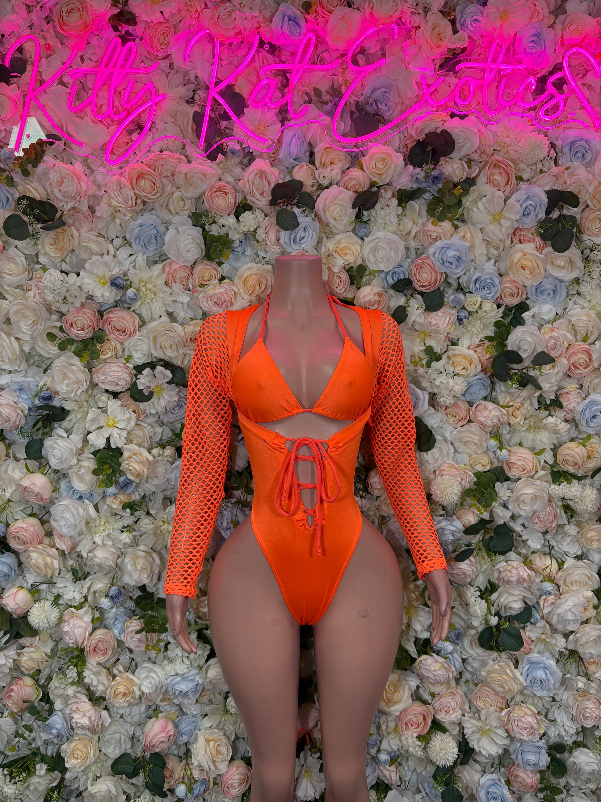 Orange halter one-piece bodysuit with fishnet sleeves, lace-up neckline, high-cut legs