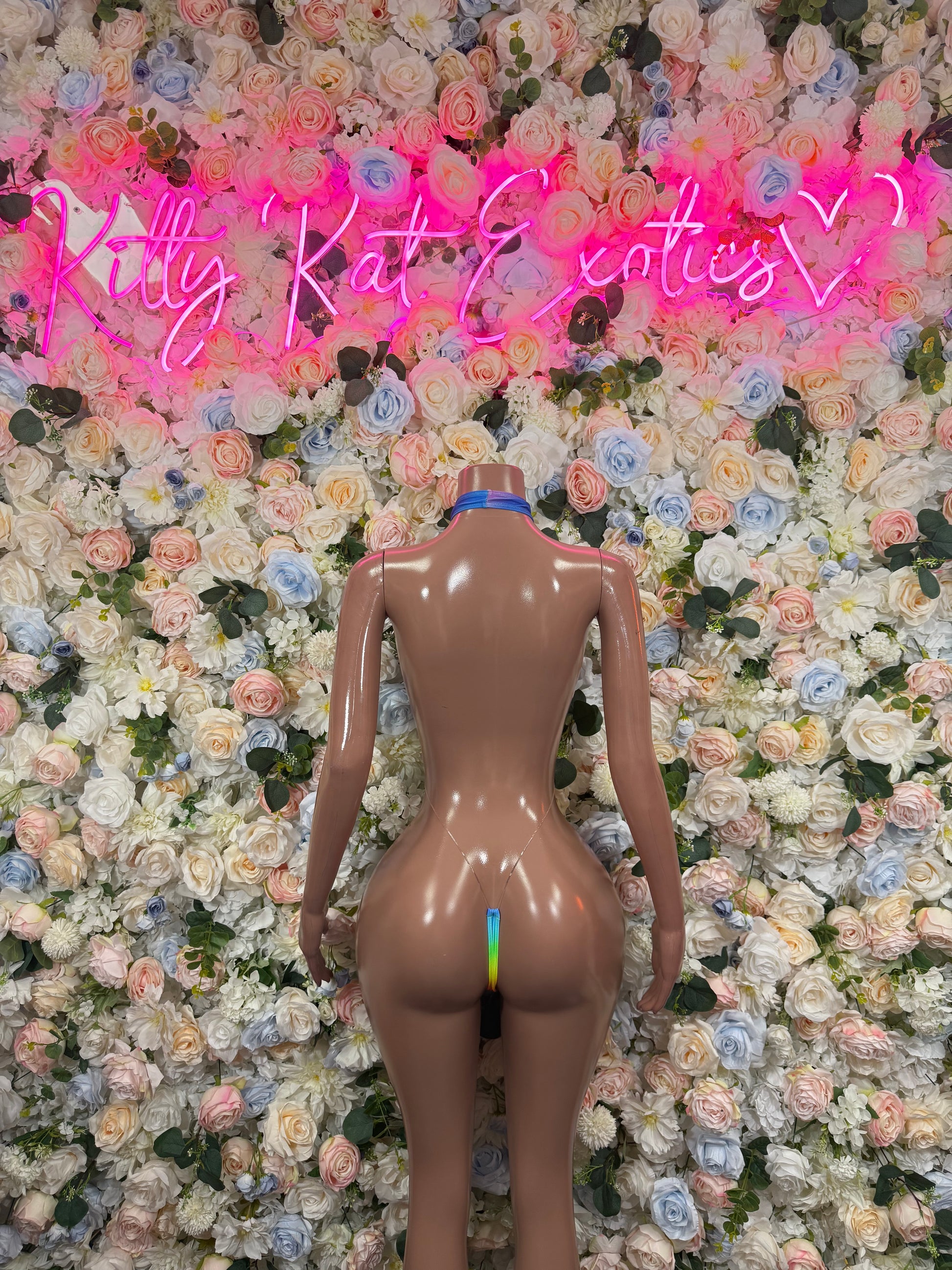 Back view multicolor one-piece bodysuit with rainbow accents and open back cut