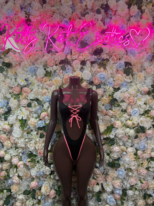 Black sheer bodysuit with pink lace-up center and V-neck, long sleeves