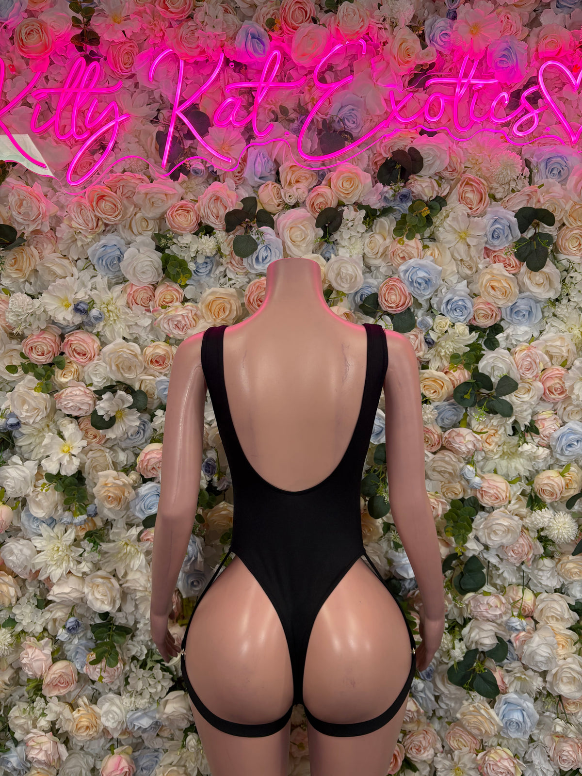 Black high-cut bodysuit with open back and thong bottom