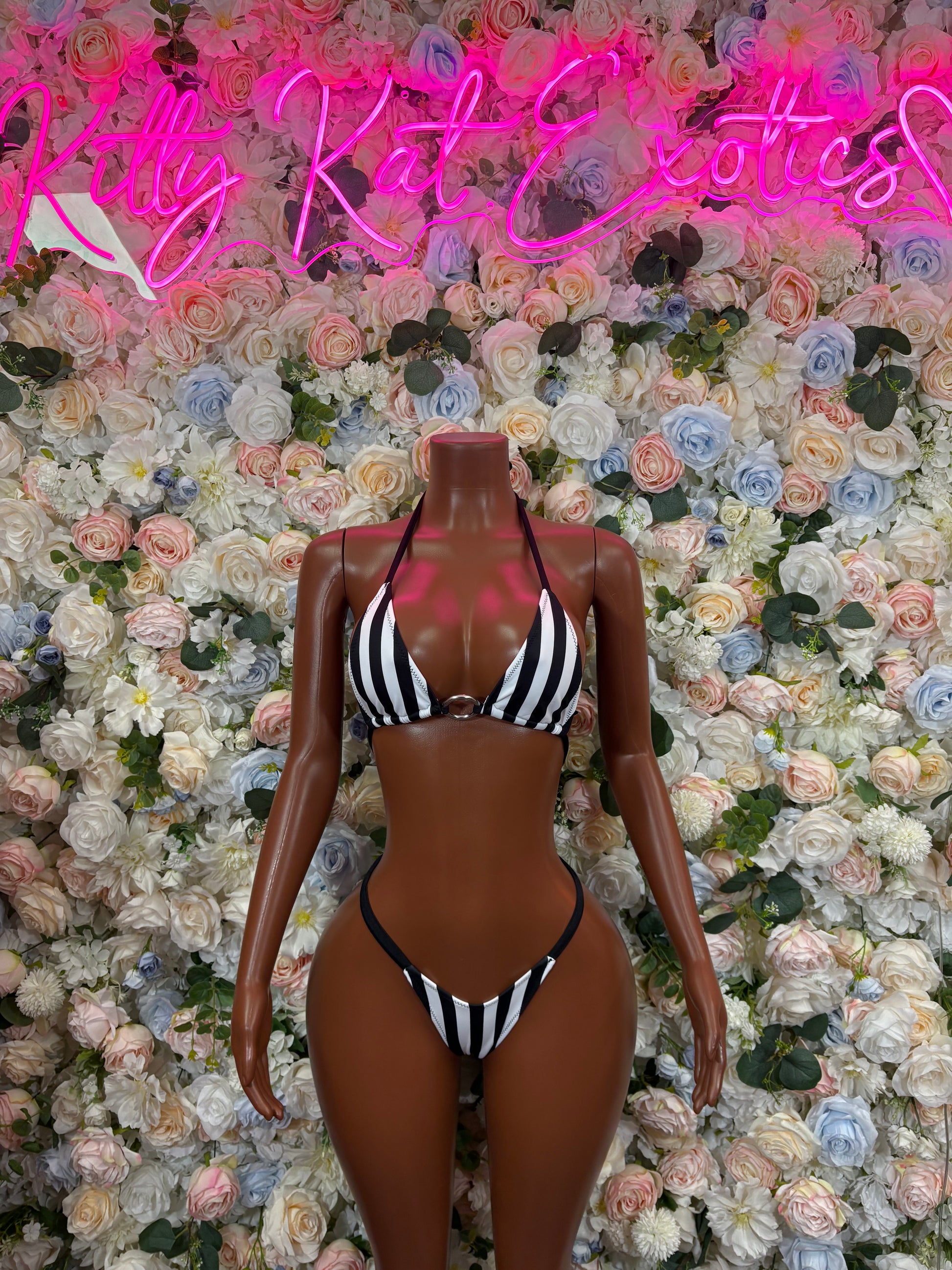 Front view of black and white striped halter bikini with triangle top and V-cut bottoms