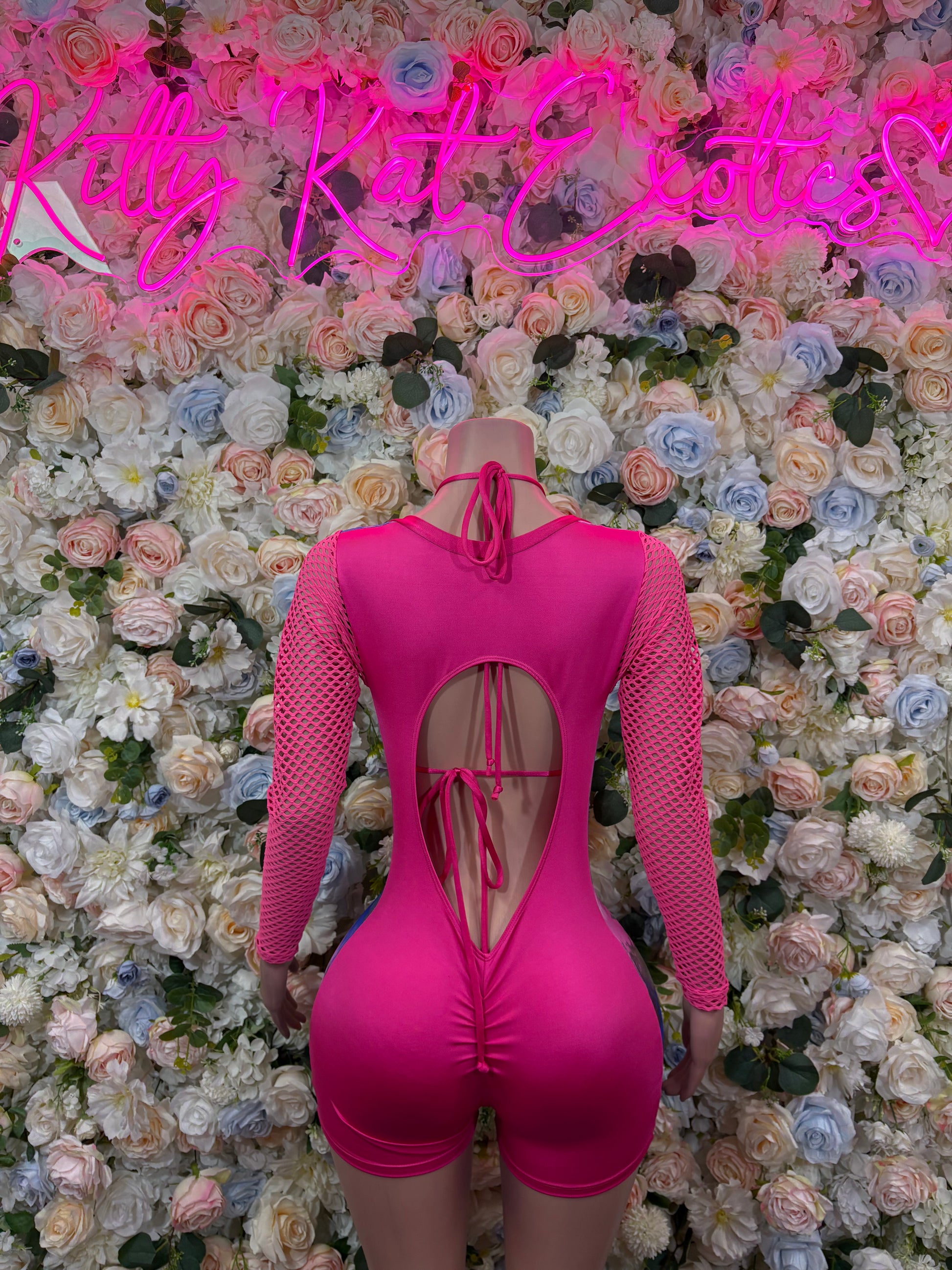 Magenta metallic bodysuit with long mesh sleeves and open-back teardrop cutout