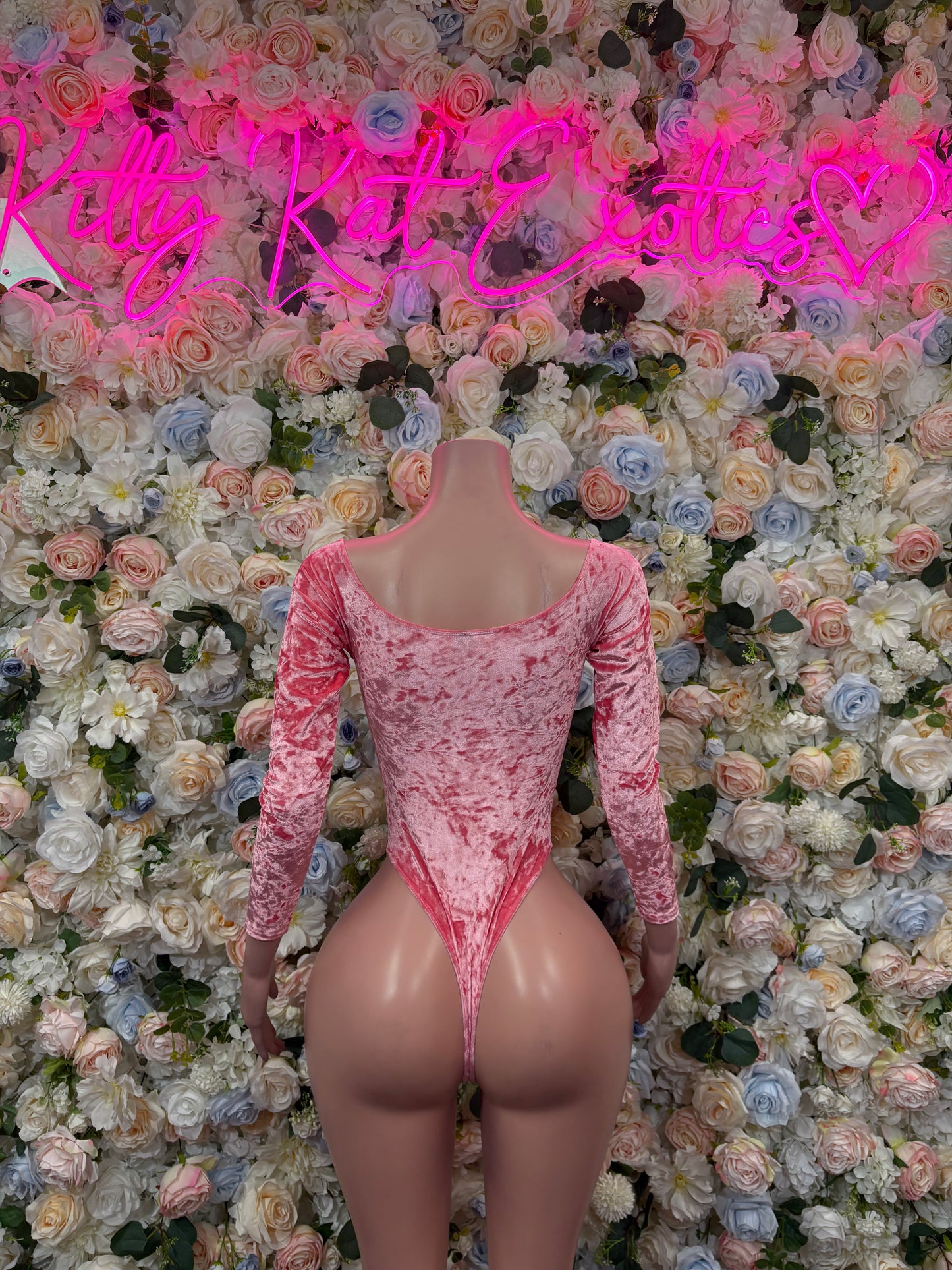 Pink velvet long-sleeve bodysuit with square neckline and cheeky thong bottom