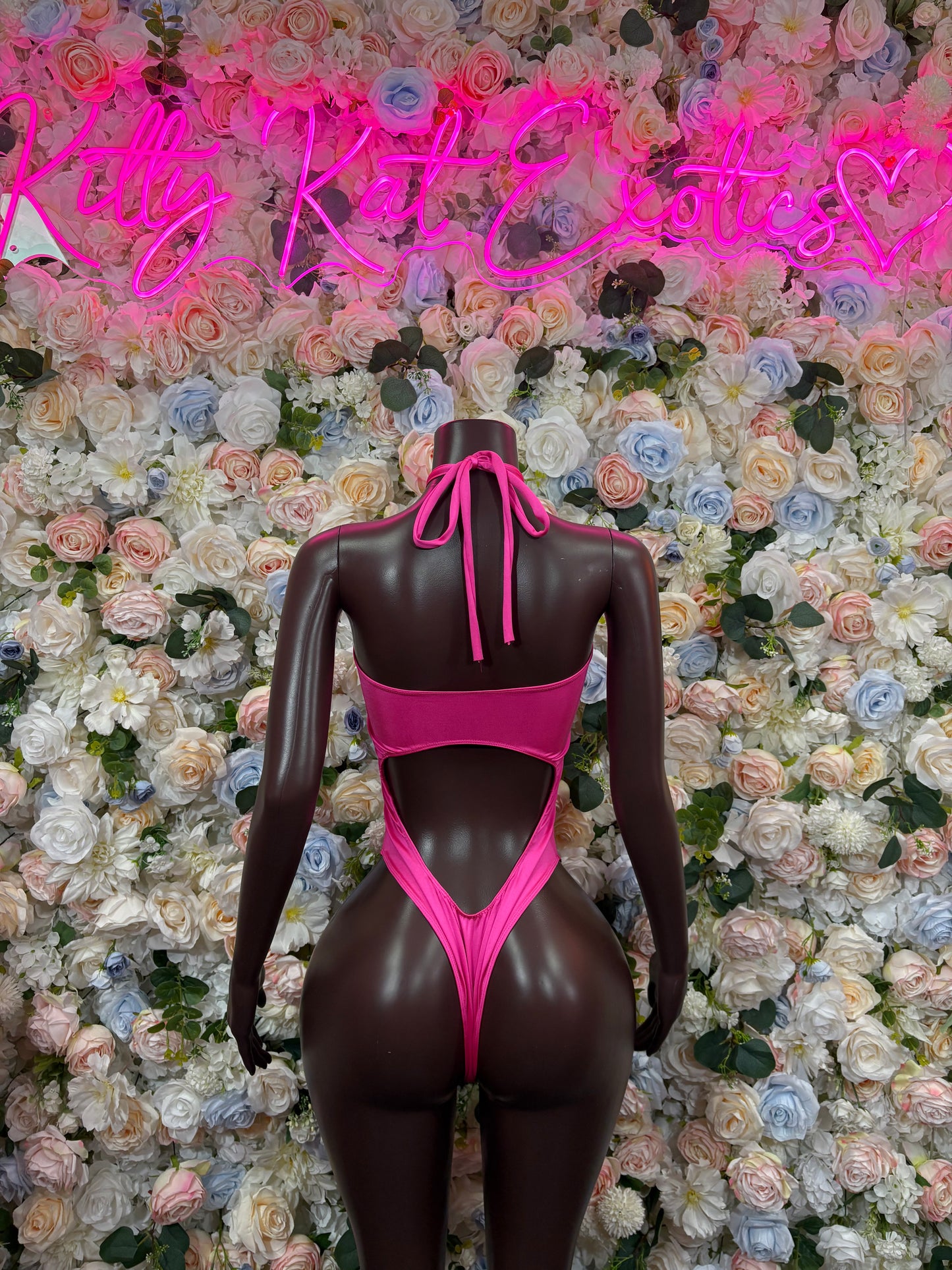 Pink bodysuit back view with center tie and deep oval back cutout