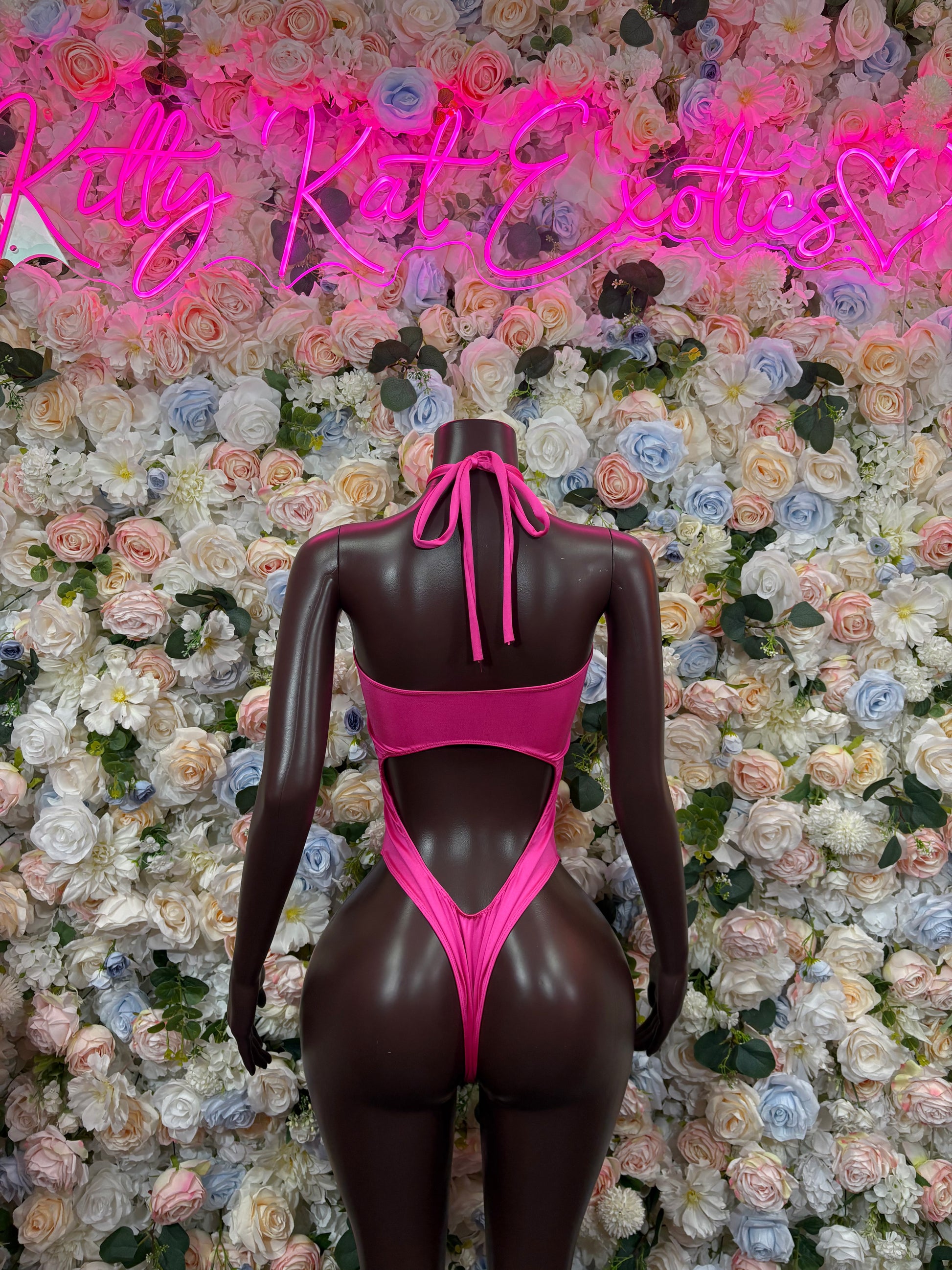 Pink bodysuit back view with center tie and deep oval back cutout