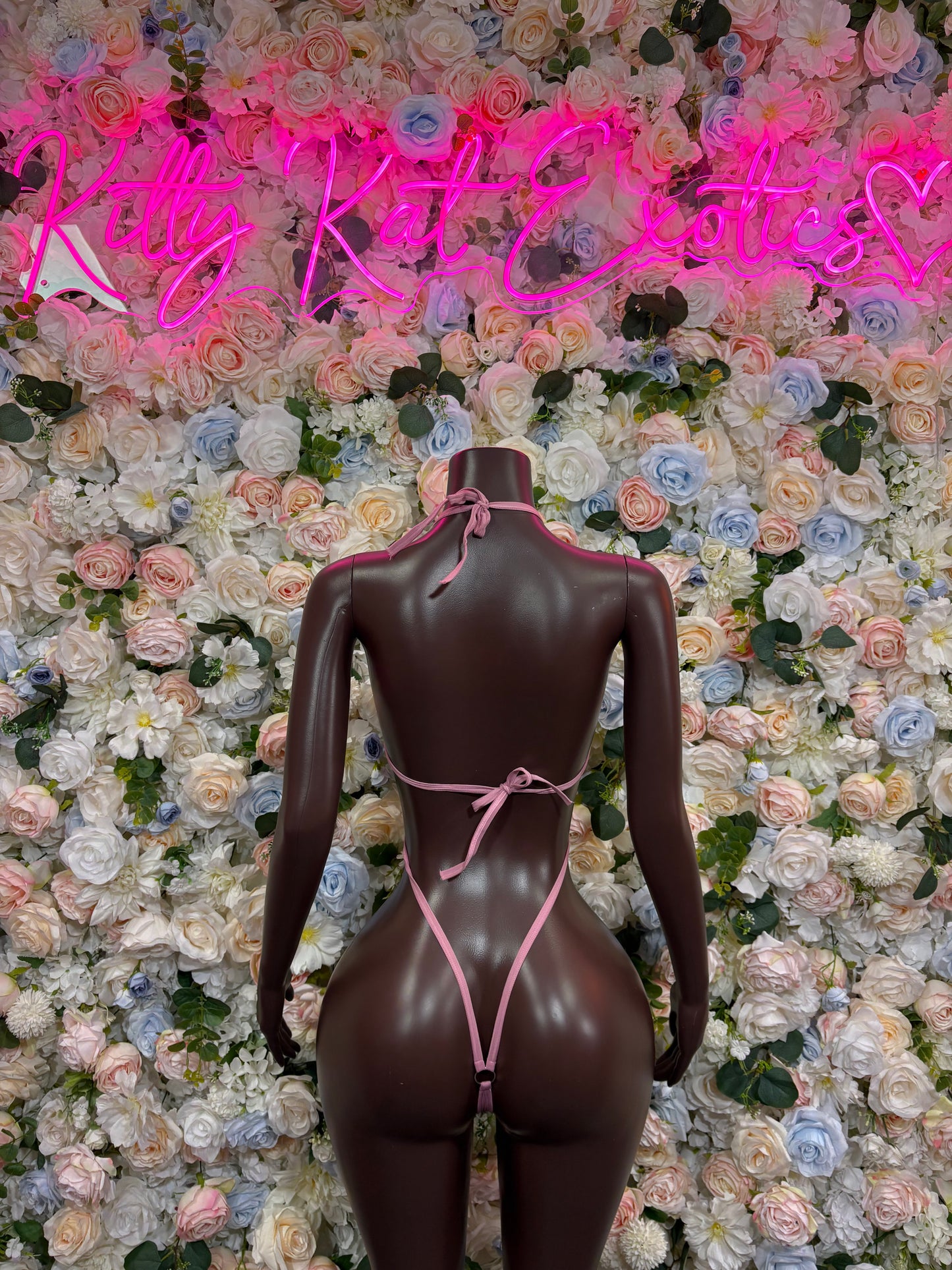 One-piece bodysuit with thong back, dark sheer fabric and adjustable pink ties